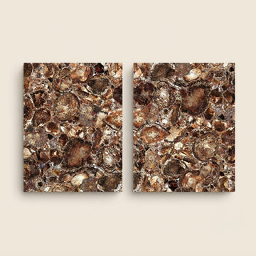 Two square abstract wall art panels with a textured, metallic-looking pattern in brown, bronze, gold, and copper tones, displayed side by side on a light beige background.