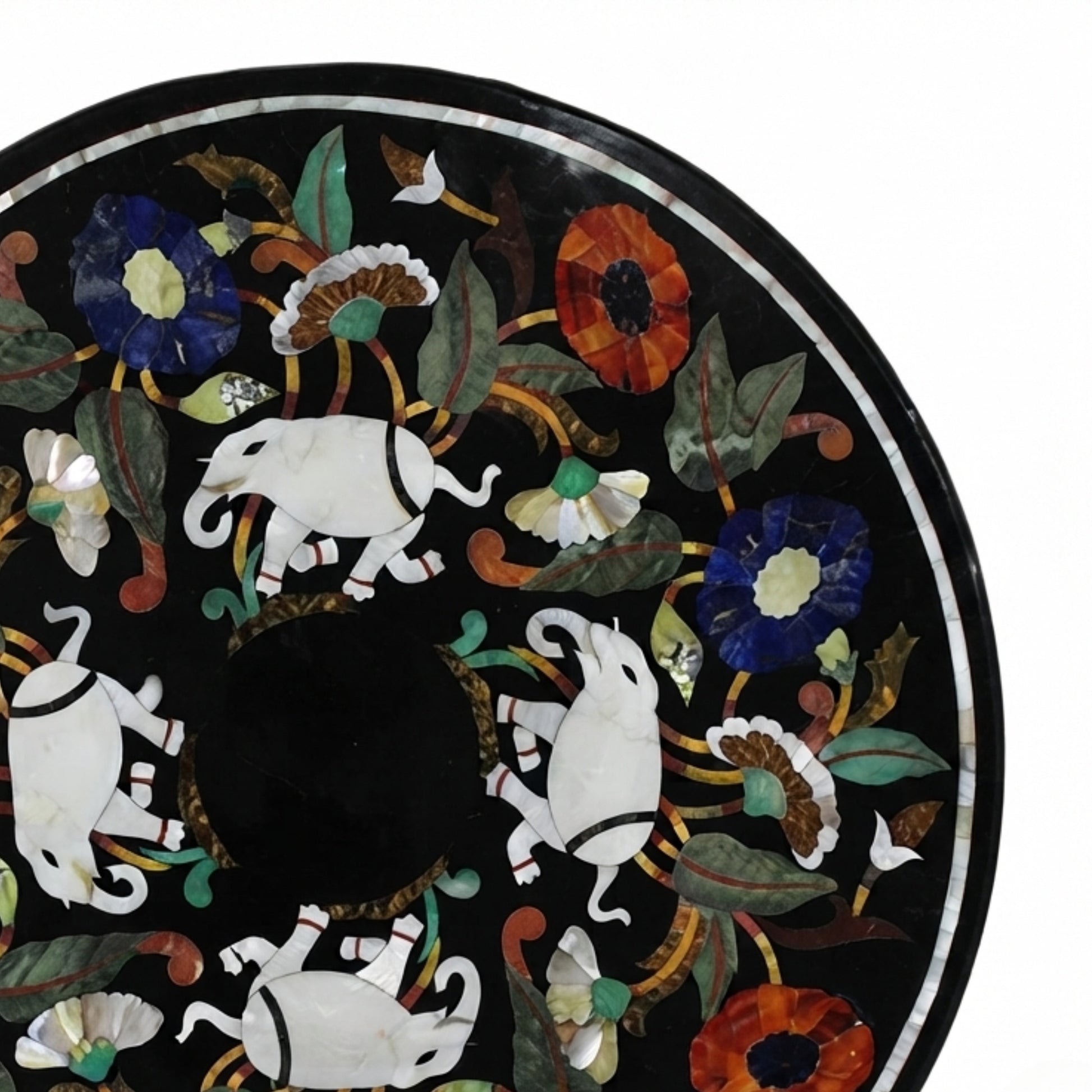 Close-up of handcrafted black marble tabletop showcasing intricate elephant and floral Pietra Dura inlay with colorful semi-precious gemstone craftsmanship.