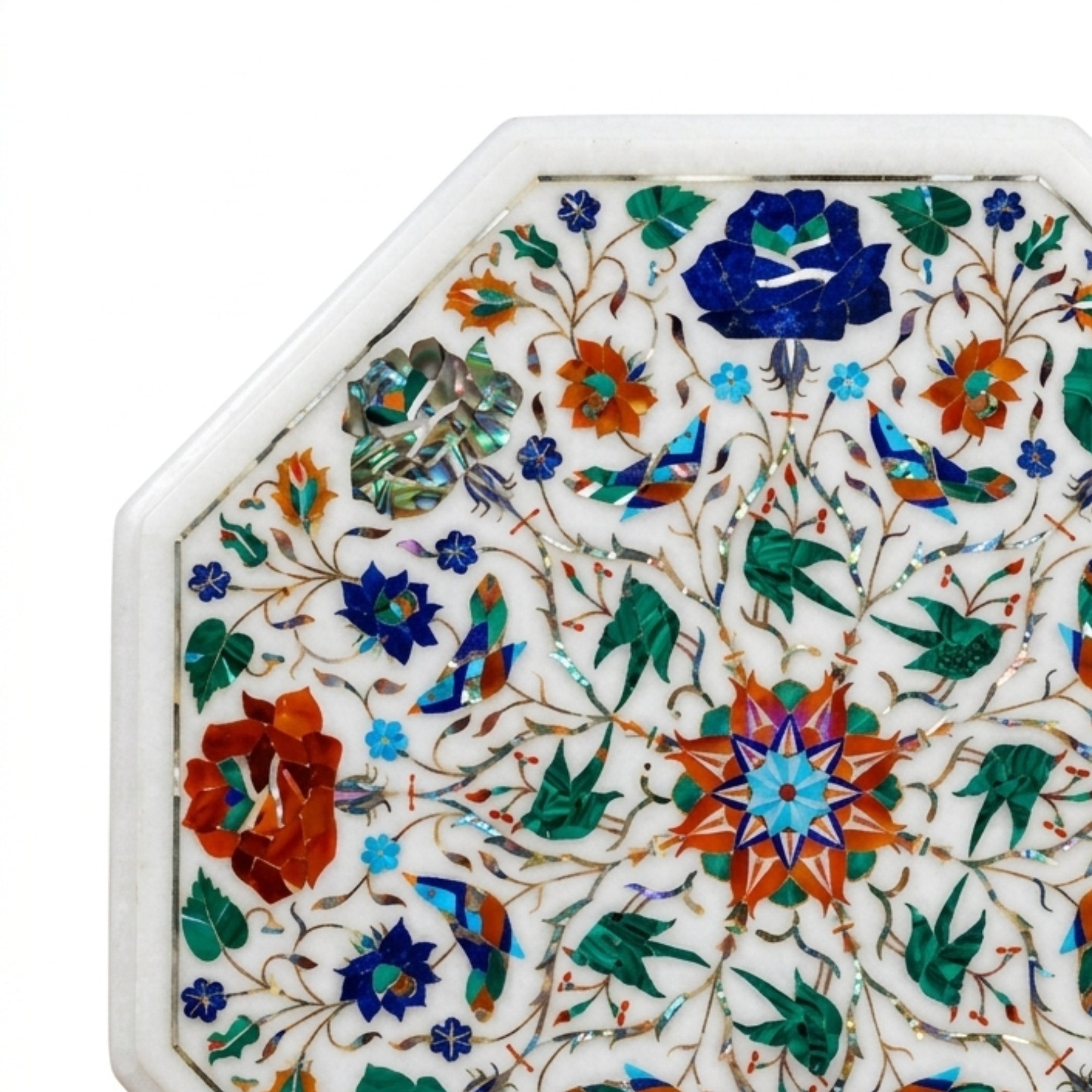 Close-up of handmade marble tabletop showcasing detailed floral Pietra Dura inlay craftsmanship with colorful semi-precious gemstones on white marble.