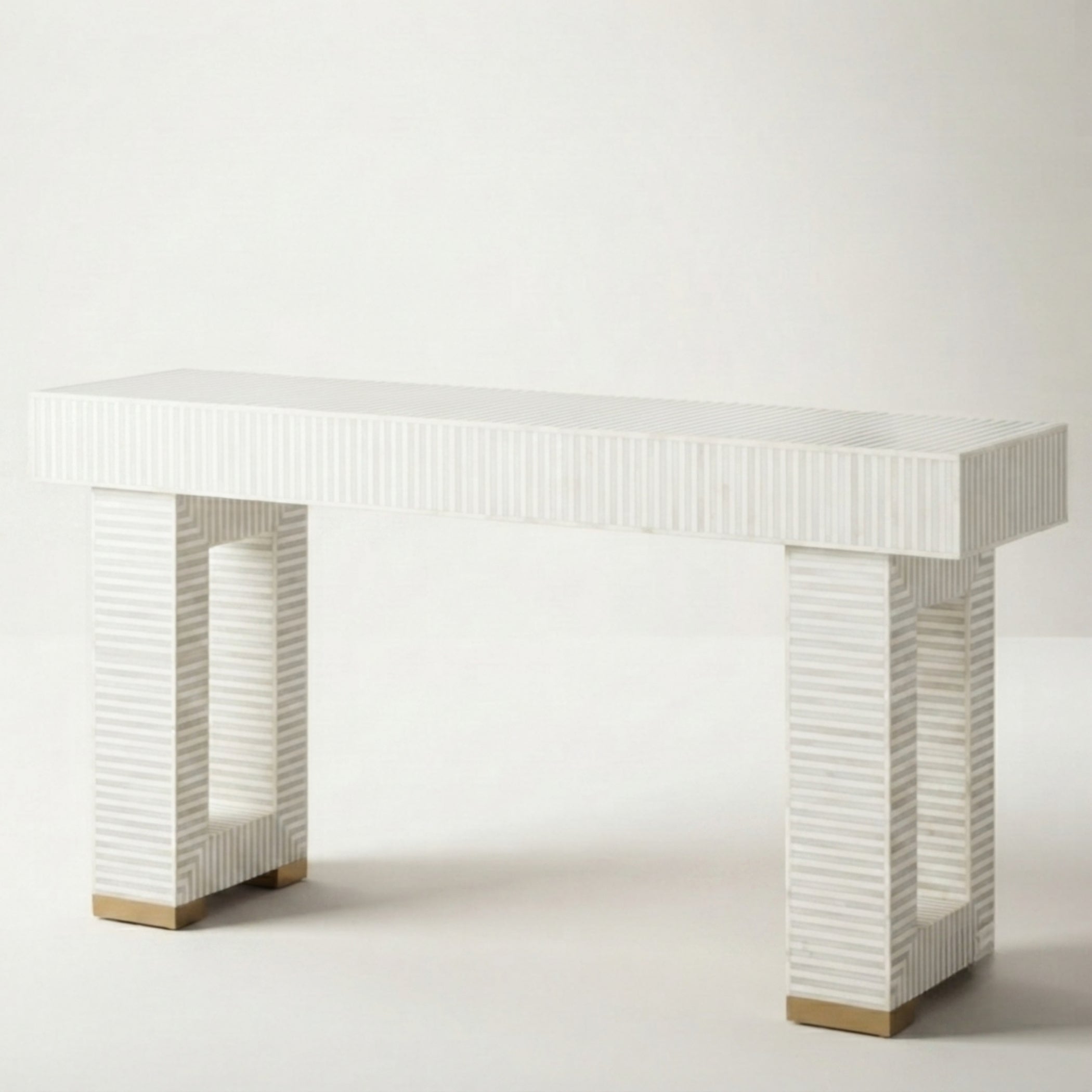 A modern console table with a white ribbed rectangular top and two matching ribbed pillar legs with light wood square feet, shown against a plain light gray studio background.