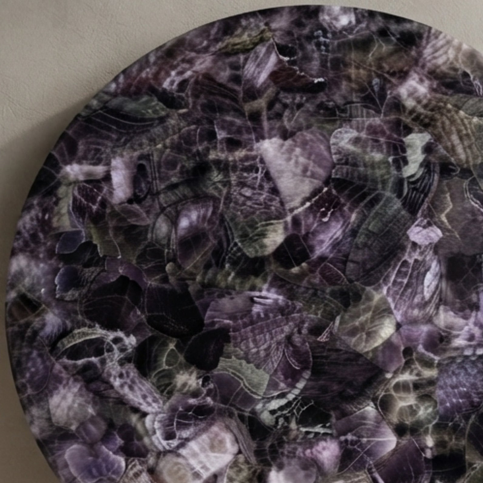 Close-up of handmade round Amethyst gemstone dining table top featuring polished natural crystal mosaic by The Regal Art