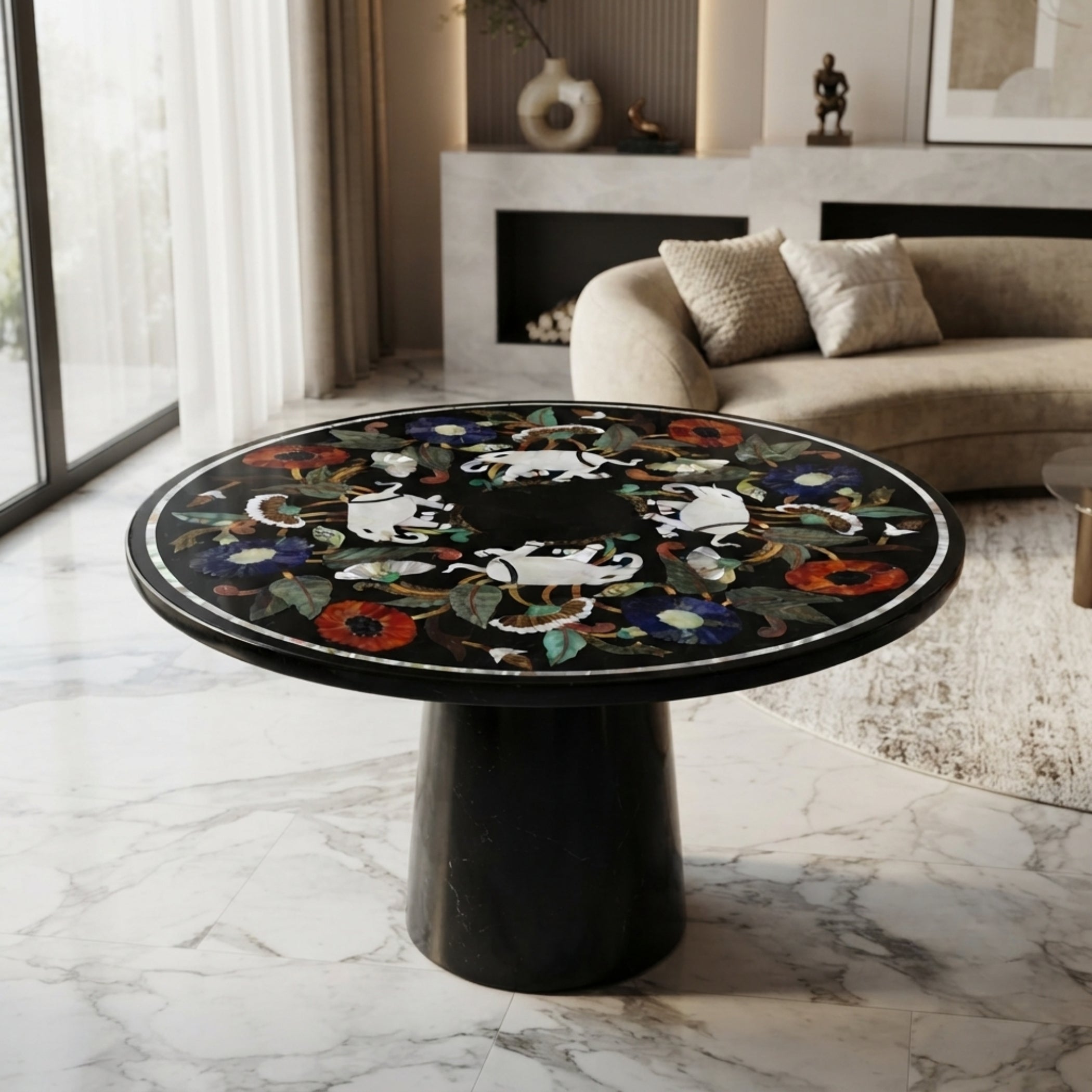Luxury handcrafted black marble round accent table with elephant and floral gemstone inlay, displayed in a contemporary living room interior.
