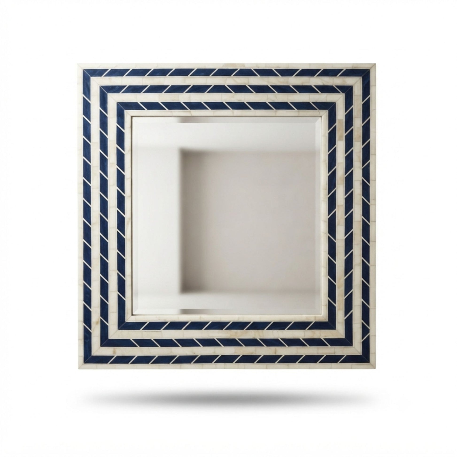 A square decorative wall mirror with a cream and navy blue geometric border pattern, shown floating against a solid white background with a soft shadow underneath.