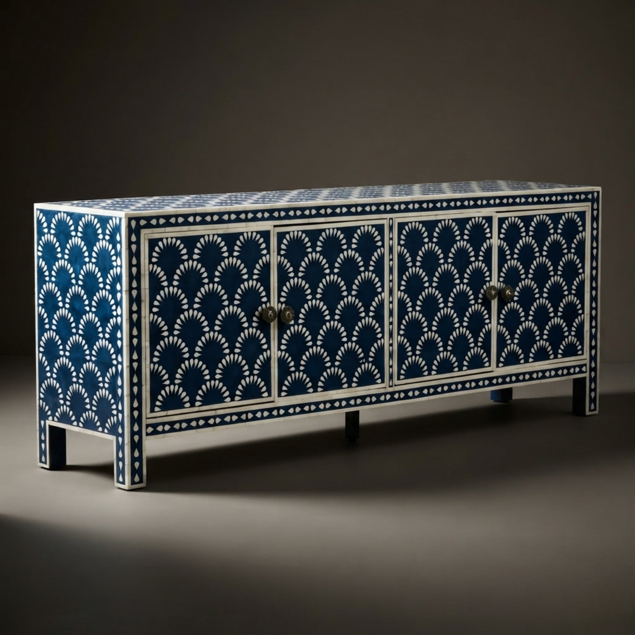 A long sideboard cabinet with four doors, decorated with an intricate blue and white fan-like inlay pattern, shown against a dark studio background.