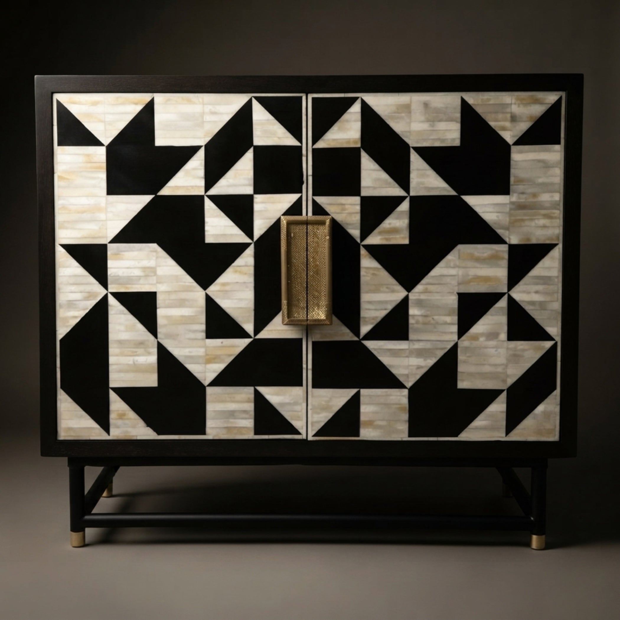 A two-door cabinet featuring a bold black and beige geometric inlay pattern on the doors, with a central gold-toned rectangular handle and a black metal frame and legs.