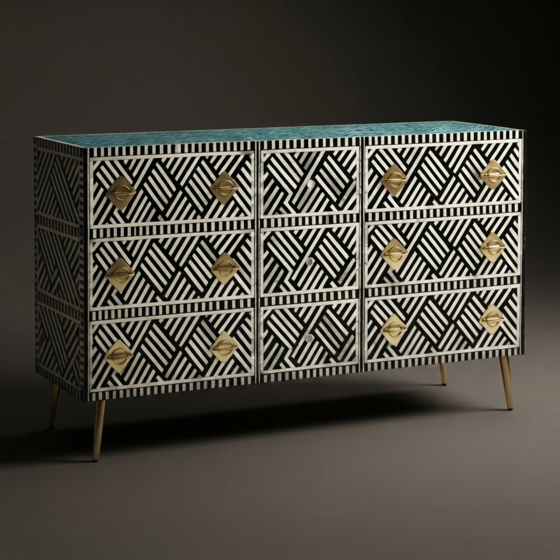 A 12-drawer sideboard cabinet featuring a black and white geometric bone-inlay pattern, gold-tone diamond-shaped hardware, and a turquoise blue top, supported by slim gold legs.