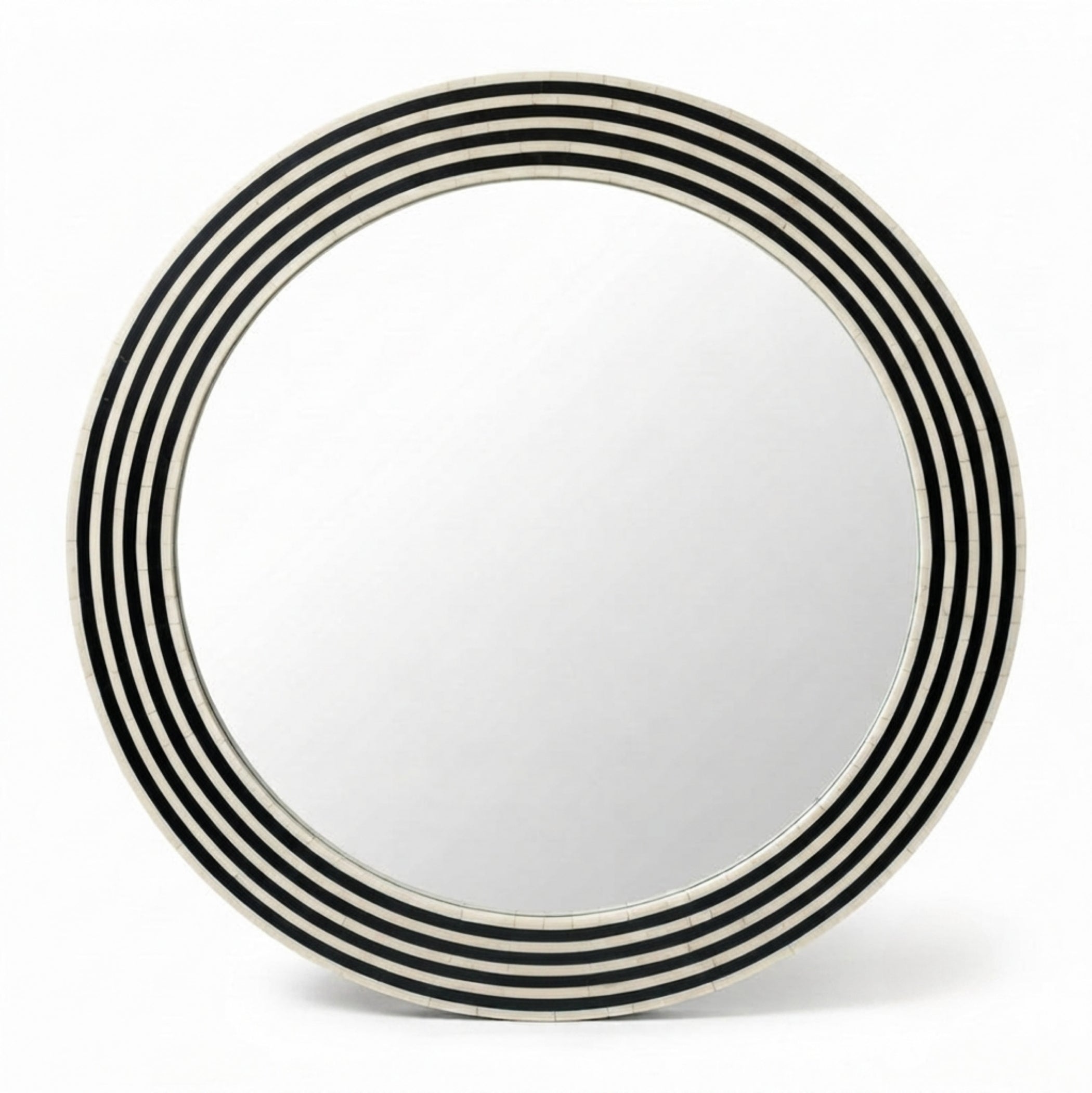 A round wall mirror with a wide decorative frame featuring alternating black and white concentric rings, shown against a plain white background.