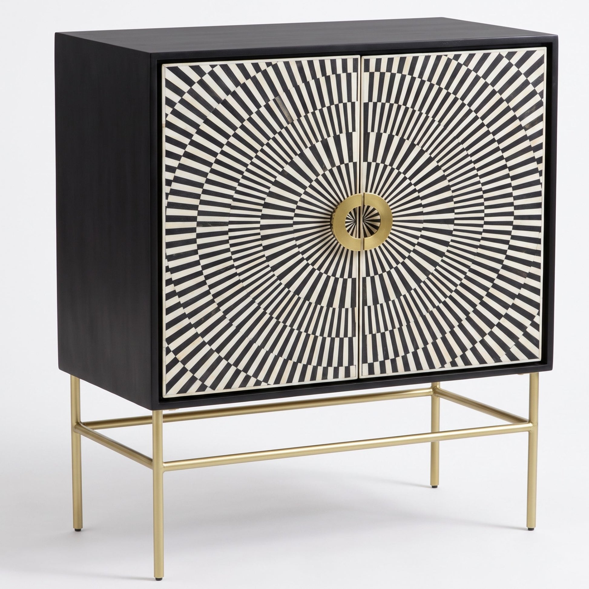 A mid-century modern sideboard cabinet with a black wood frame, doors featuring a black and white geometric sunburst pattern, and a round gold pull handle, supported by a slim gold metal stand.