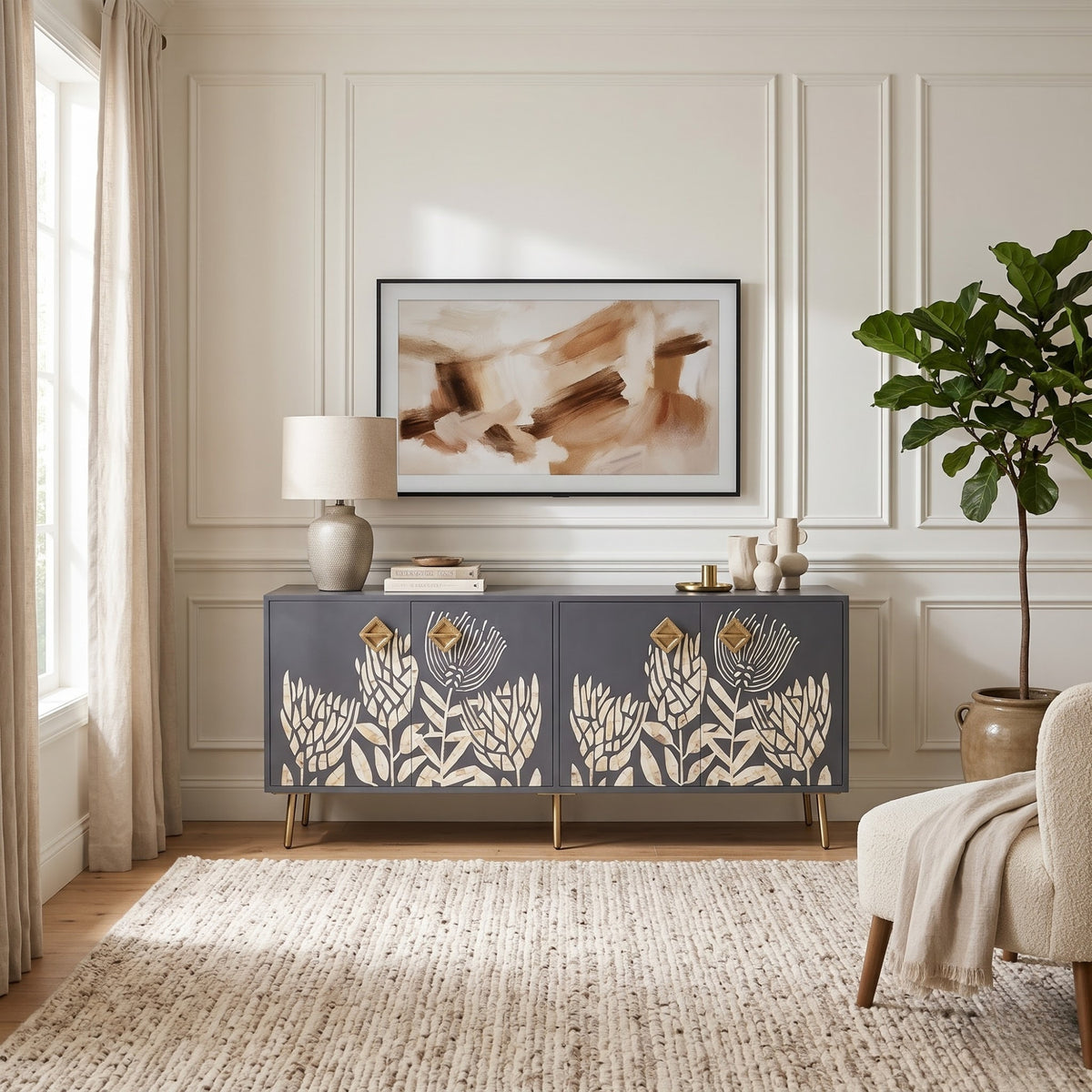 A mid-century modern sideboard cabinet in slate blue with cream floral cutout doors and gold legs, styled in a bright living room setting.