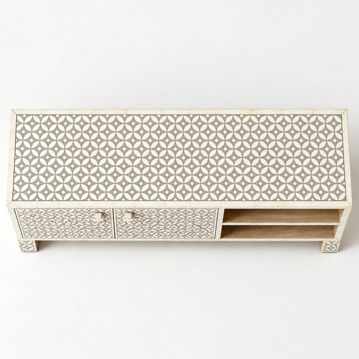 A rectangular sideboard or media console with an intricate geometric inlay pattern in beige and white, featuring two doors on the left and open shelving on the right, set against a plain white background.