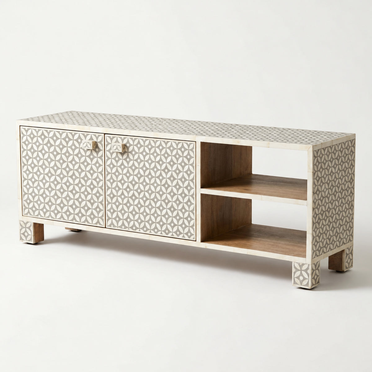 A modern media console with a bone-inlay geometric pattern on the doors and sides, featuring a light wood frame and open shelving, photographed on a seamless white background.