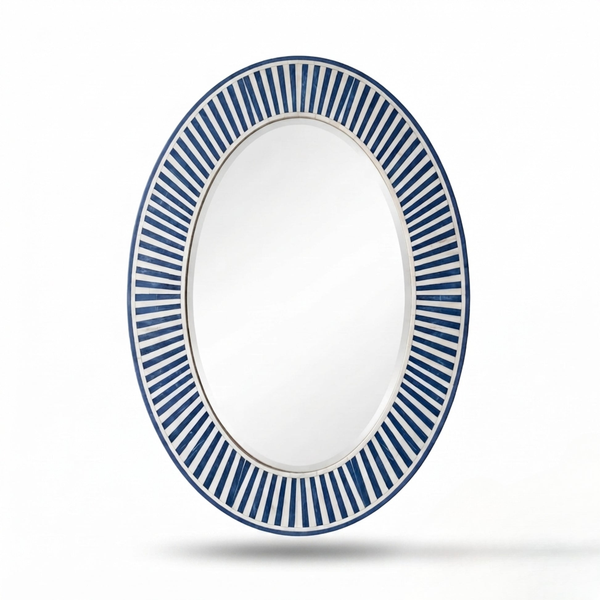 An oval wall mirror with a white frame featuring a decorative border of alternating blue and white radiating stripes, shown against a plain white background with a soft shadow underneath.