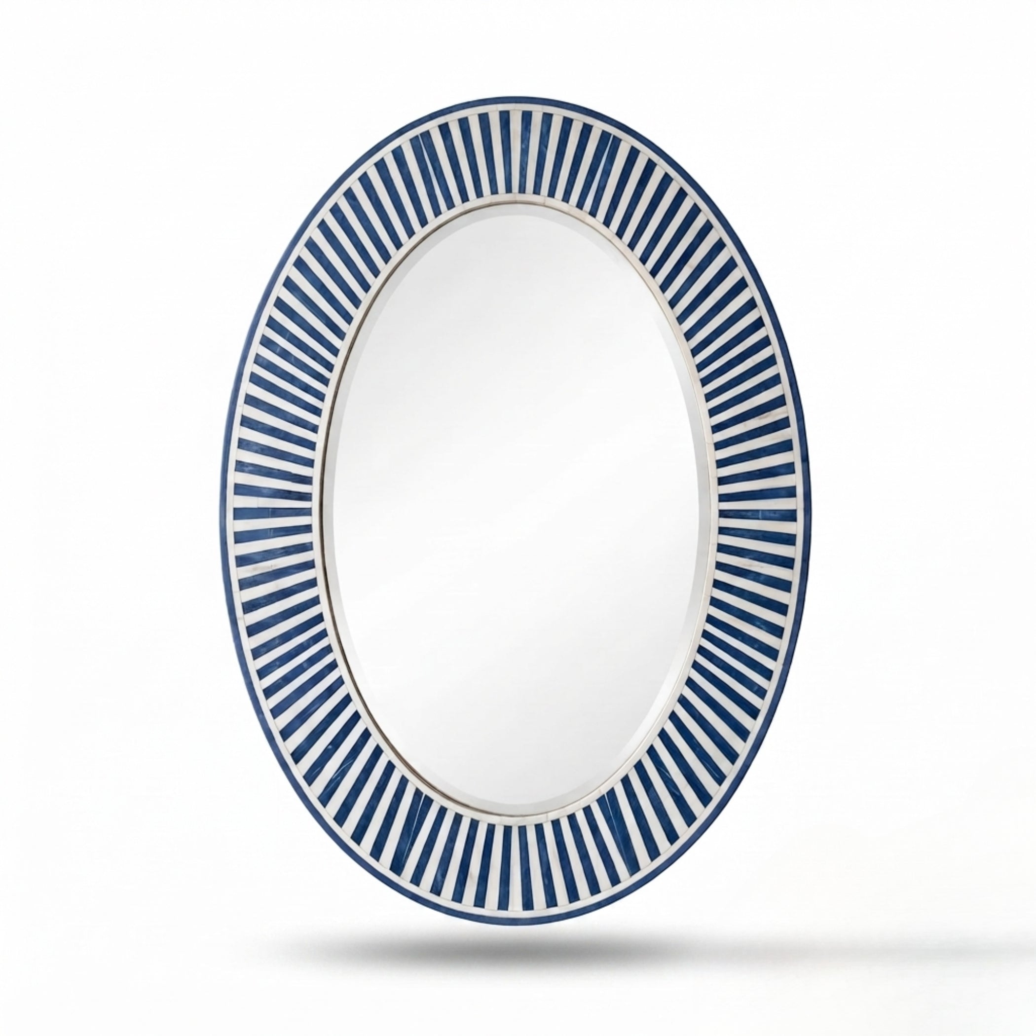 An oval wall mirror with a white frame featuring a decorative border of alternating blue and white radiating stripes, shown against a plain white background with a soft shadow underneath.