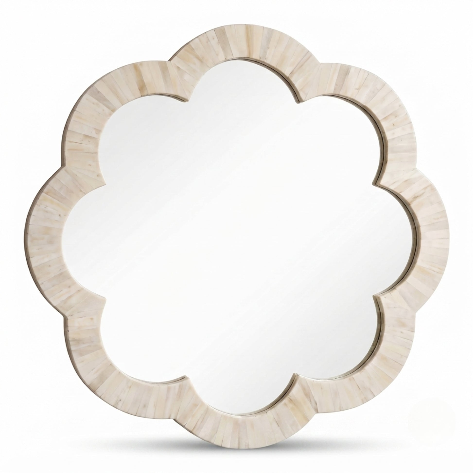 A scalloped flower-shaped wall mirror with a light beige bone or shell-look frame, shown against a plain white background.