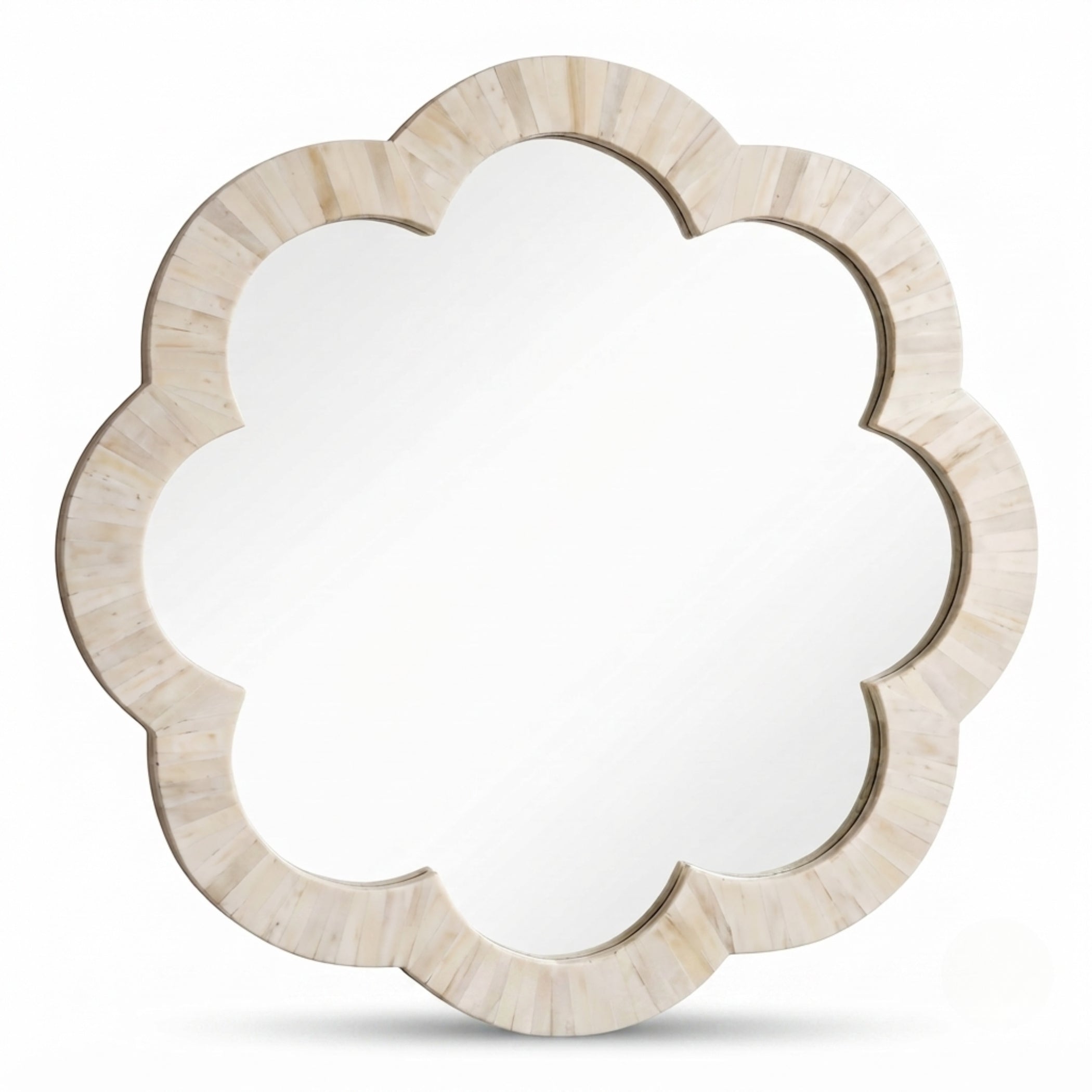 A scalloped flower-shaped wall mirror with a light beige bone or shell-look frame, shown against a plain white background.