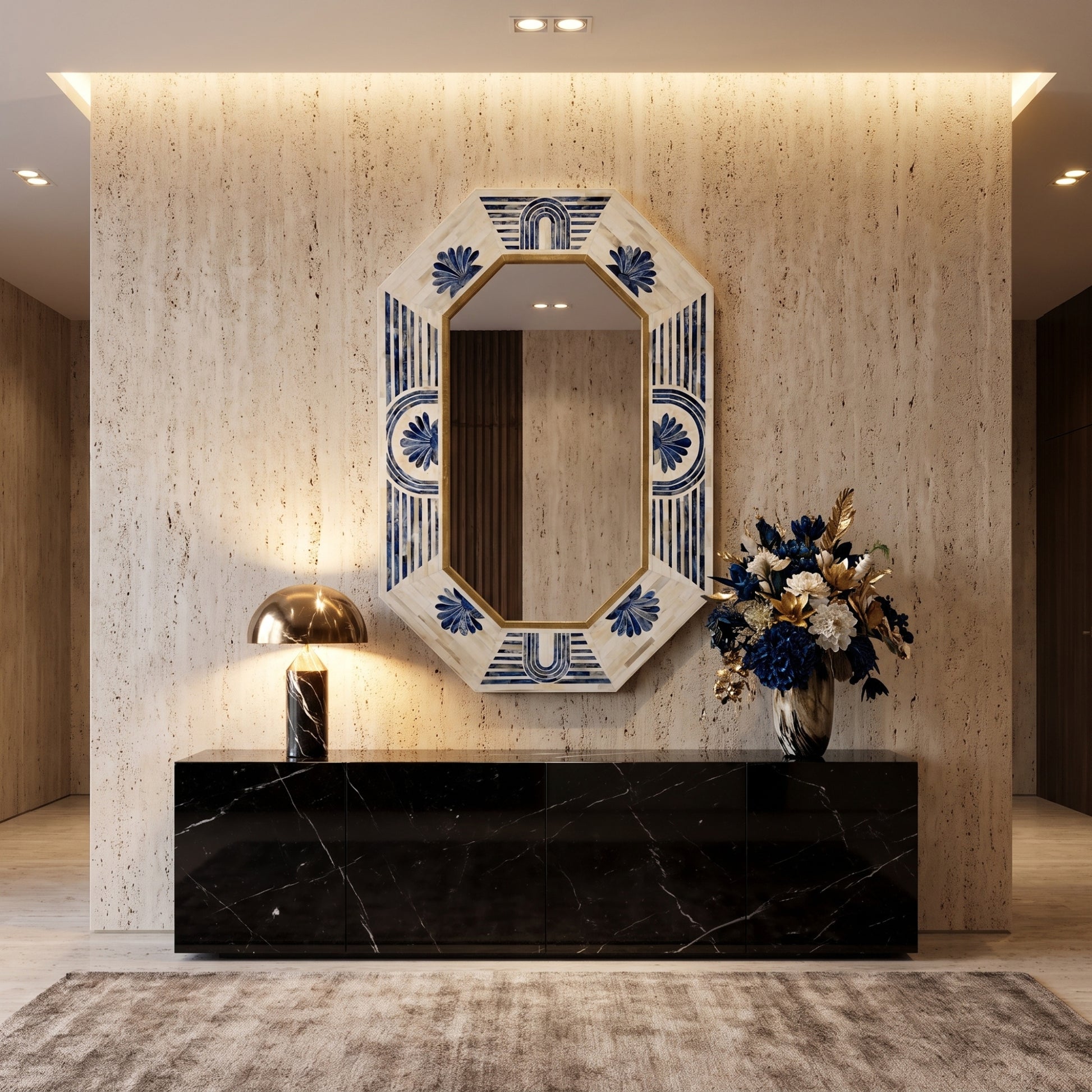 An octagonal wall mirror with a cream and blue floral patterned frame hangs above a black marble console in a modern, warmly lit entryway.