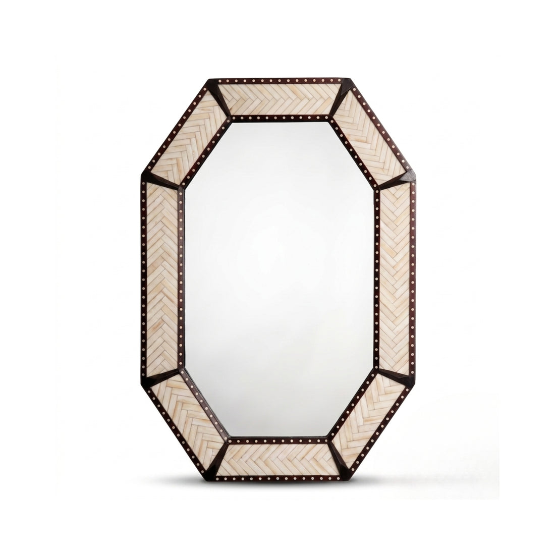 An octagonal wall mirror with a dark bronze frame and cream chevron-patterned panels, mounted on a textured beige wall above a floating wooden shelf in a styled interior setting.