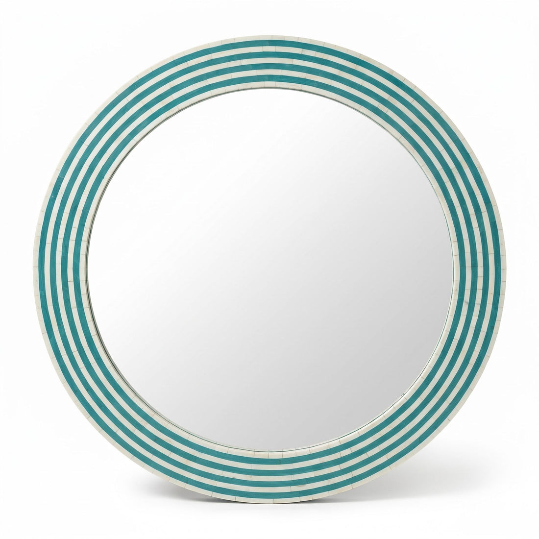 A round wall mirror with a striped turquoise and white frame, mounted on a beige wall in a modern living room setting.