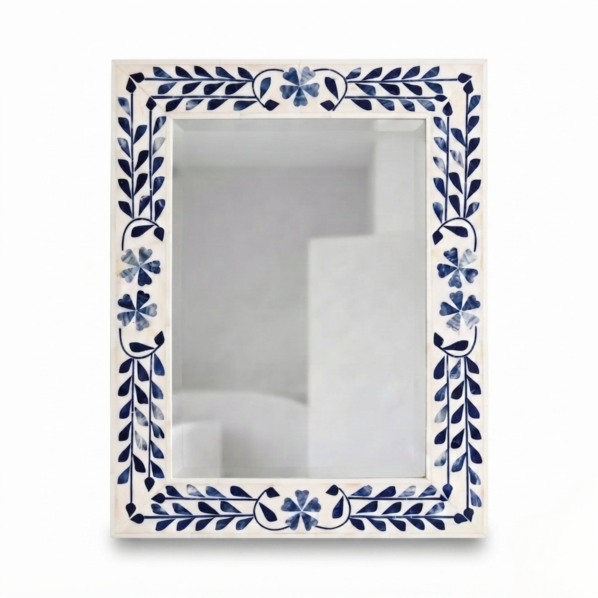A rectangular wall mirror with an ornate cream-colored border decorated with blue floral and leaf motifs, shown against a plain white background.