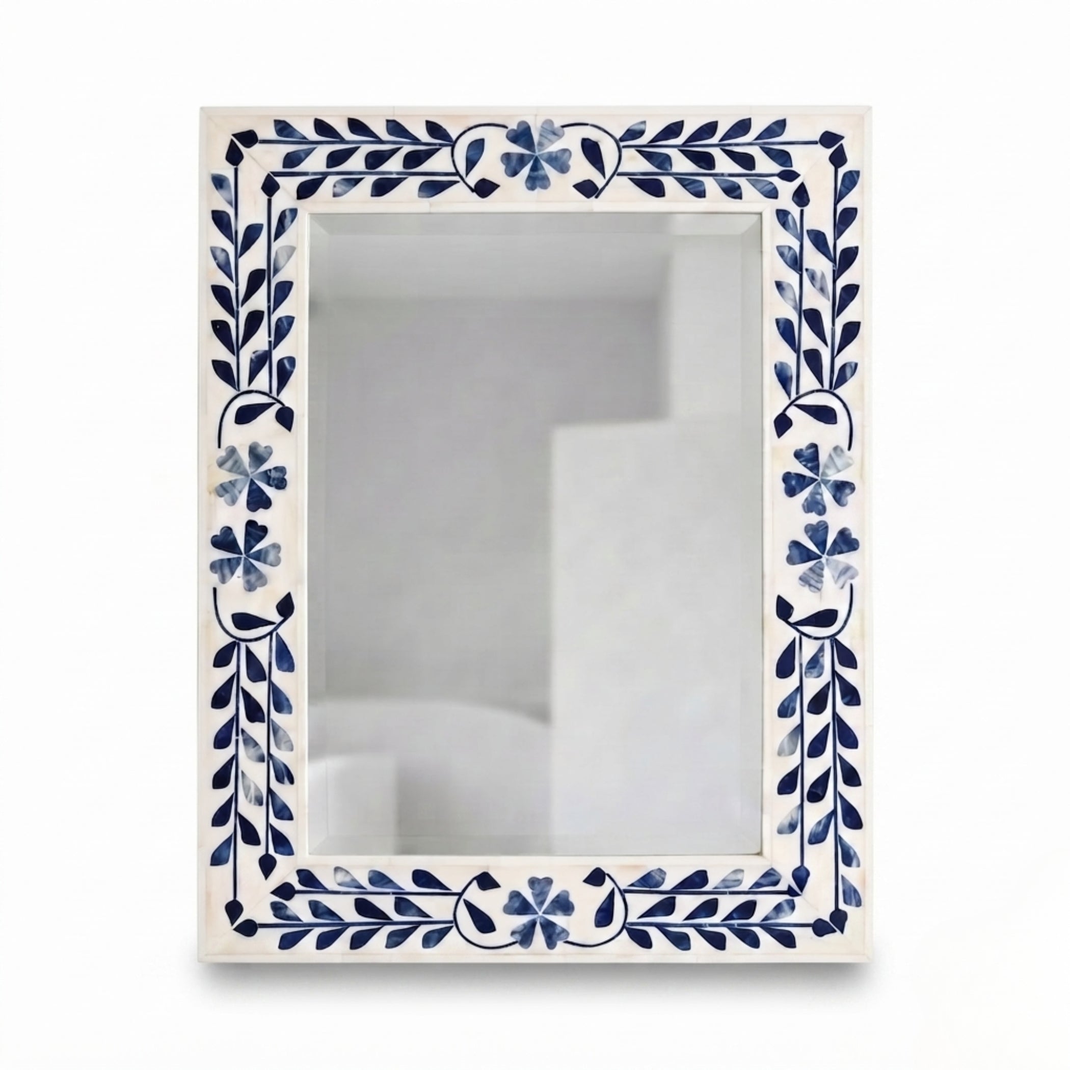 A rectangular wall mirror with an ornate cream-colored border decorated with blue floral and leaf motifs, shown against a plain white background.