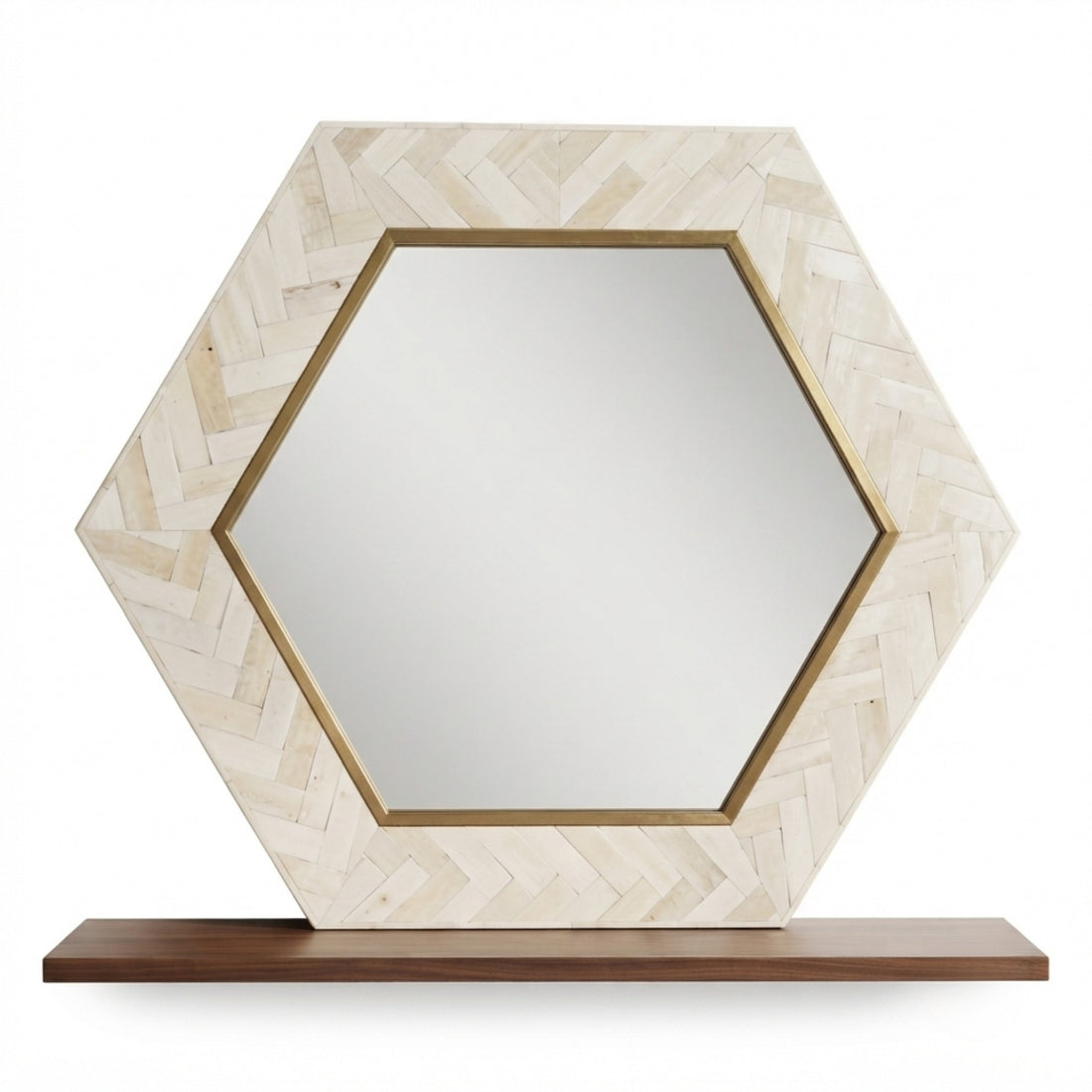 Hexagonal wall mirror with a light beige herringbone-patterned frame and gold trim, displayed on a dark wood shelf against a textured beige wall with a gold wall sconce.