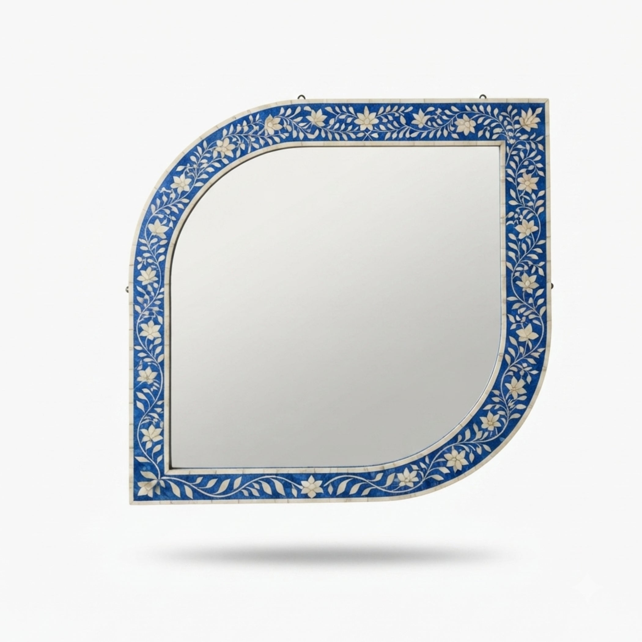 A decorative wall mirror with a blue and white floral bone-inlay frame, shown against a light gray background with a soft drop shadow.