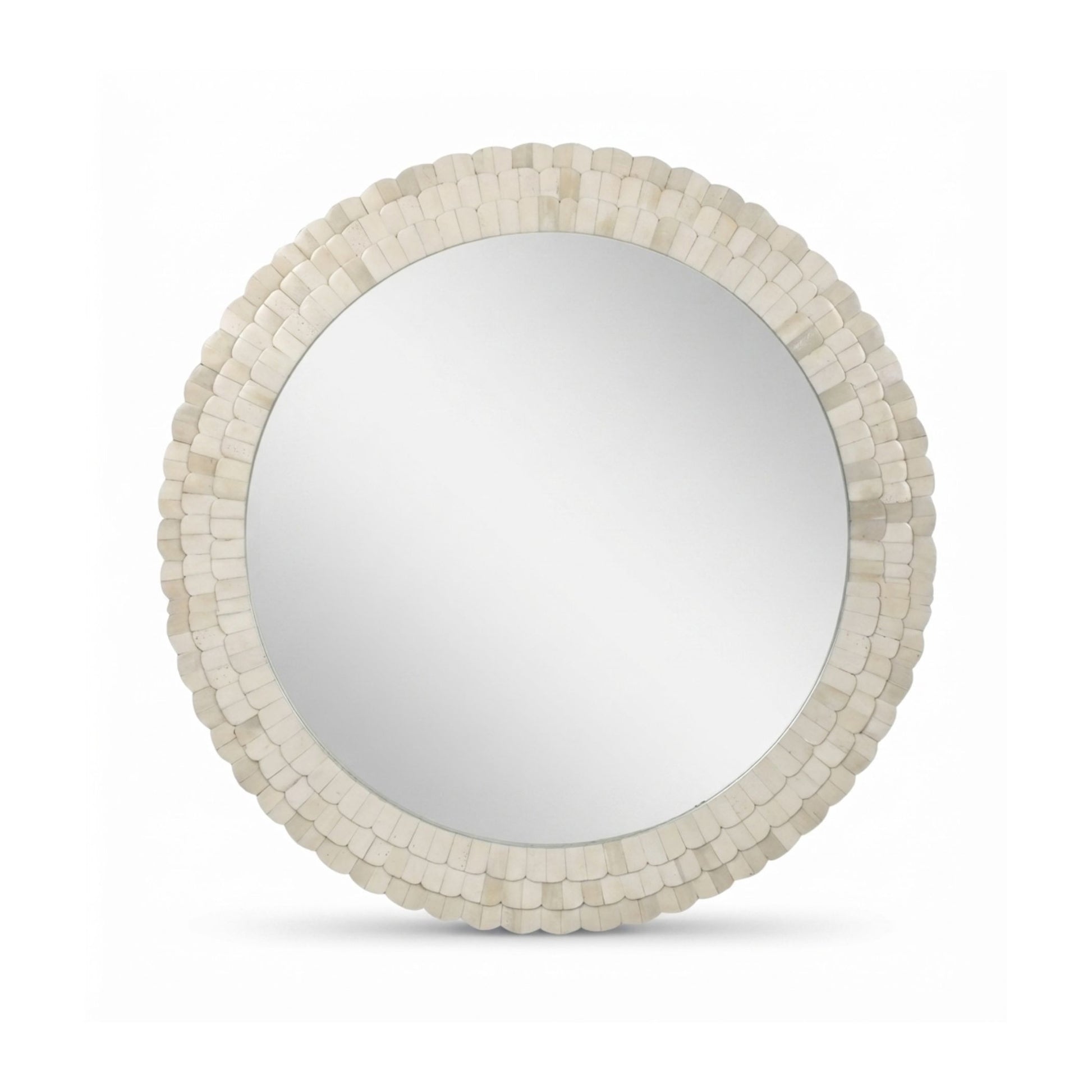 Round wall mirror with a textured, scalloped frame made of small stacked shell-like pieces in an off-white finish, shown on a plain white background.