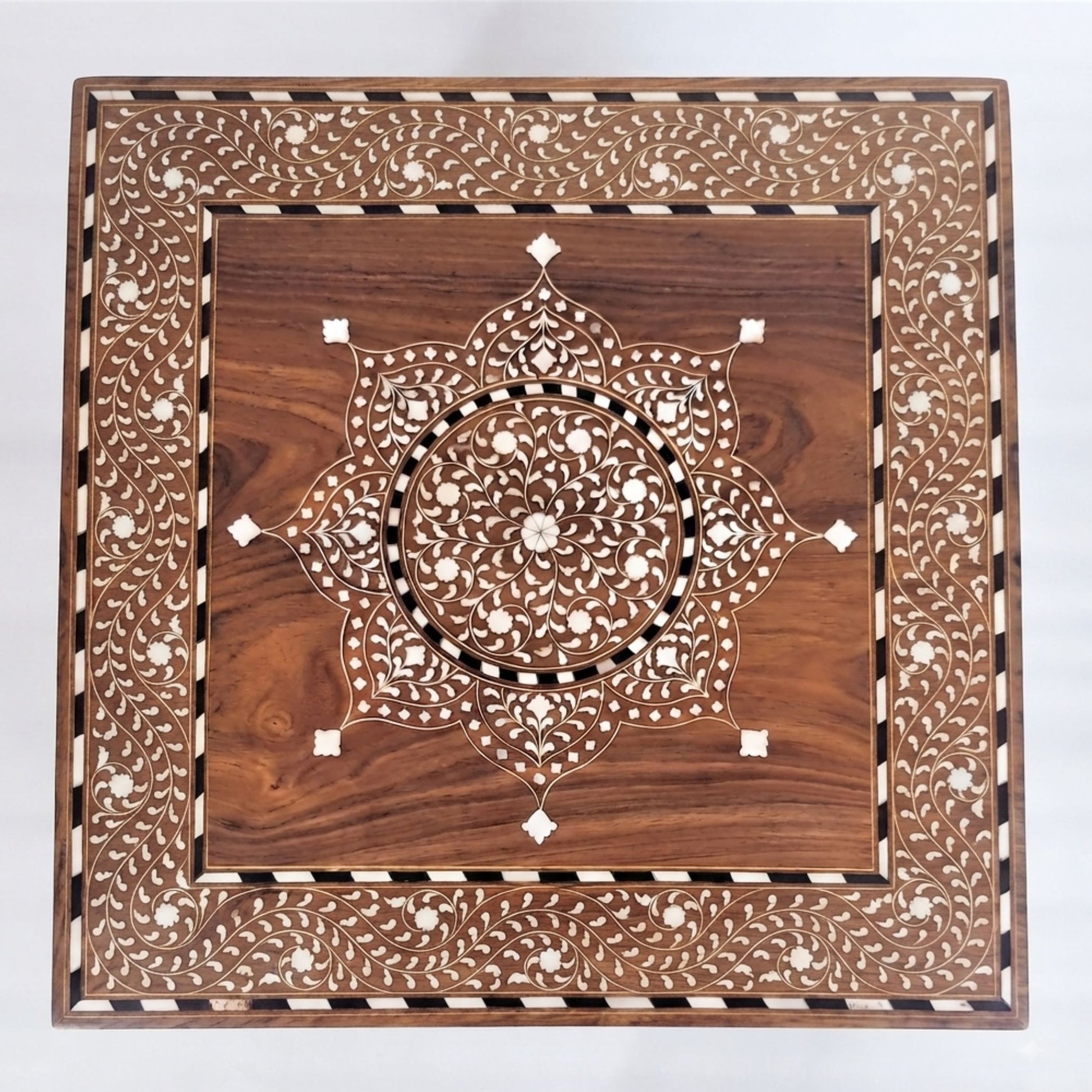 A square wooden decorative board with intricate inlay work, featuring a central mandala pattern and a detailed border, shown on a plain white background.
