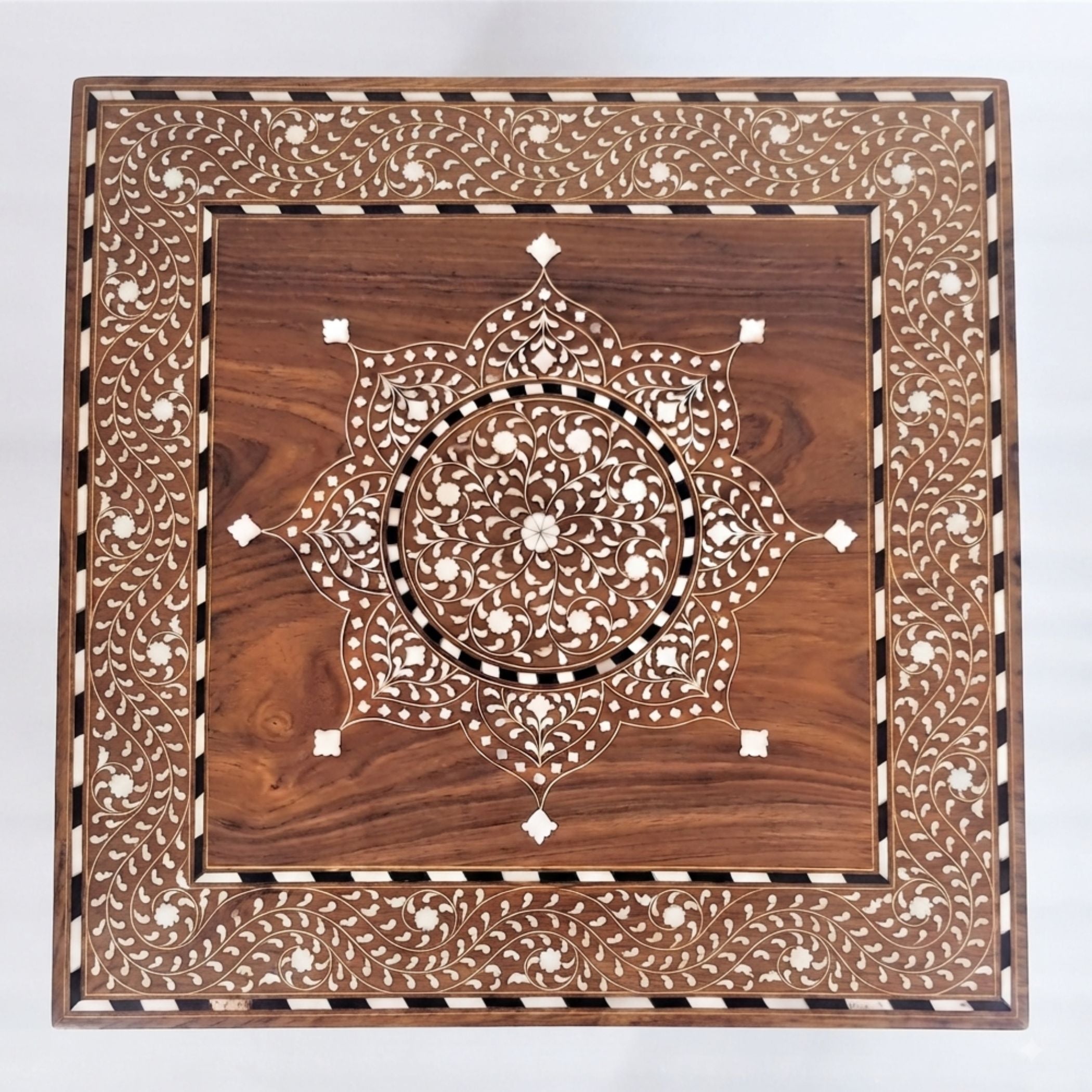 A square wooden decorative board with intricate inlay work, featuring a central mandala pattern and a detailed border, shown on a plain white background.