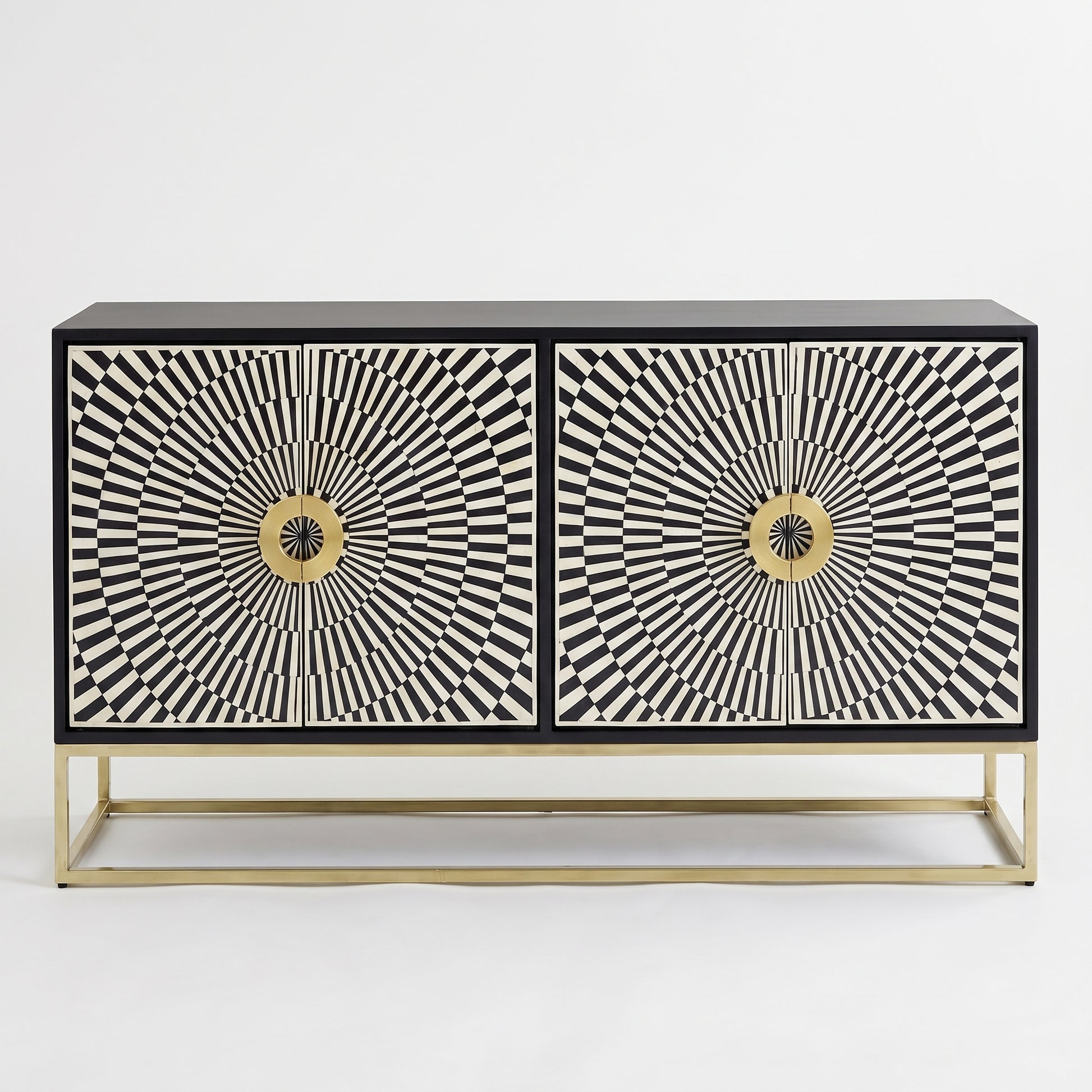 A modern two-door sideboard cabinet featuring black and white geometric sunburst patterns on the doors, a black top and base, and a slim gold metal frame, shown against a plain white background.