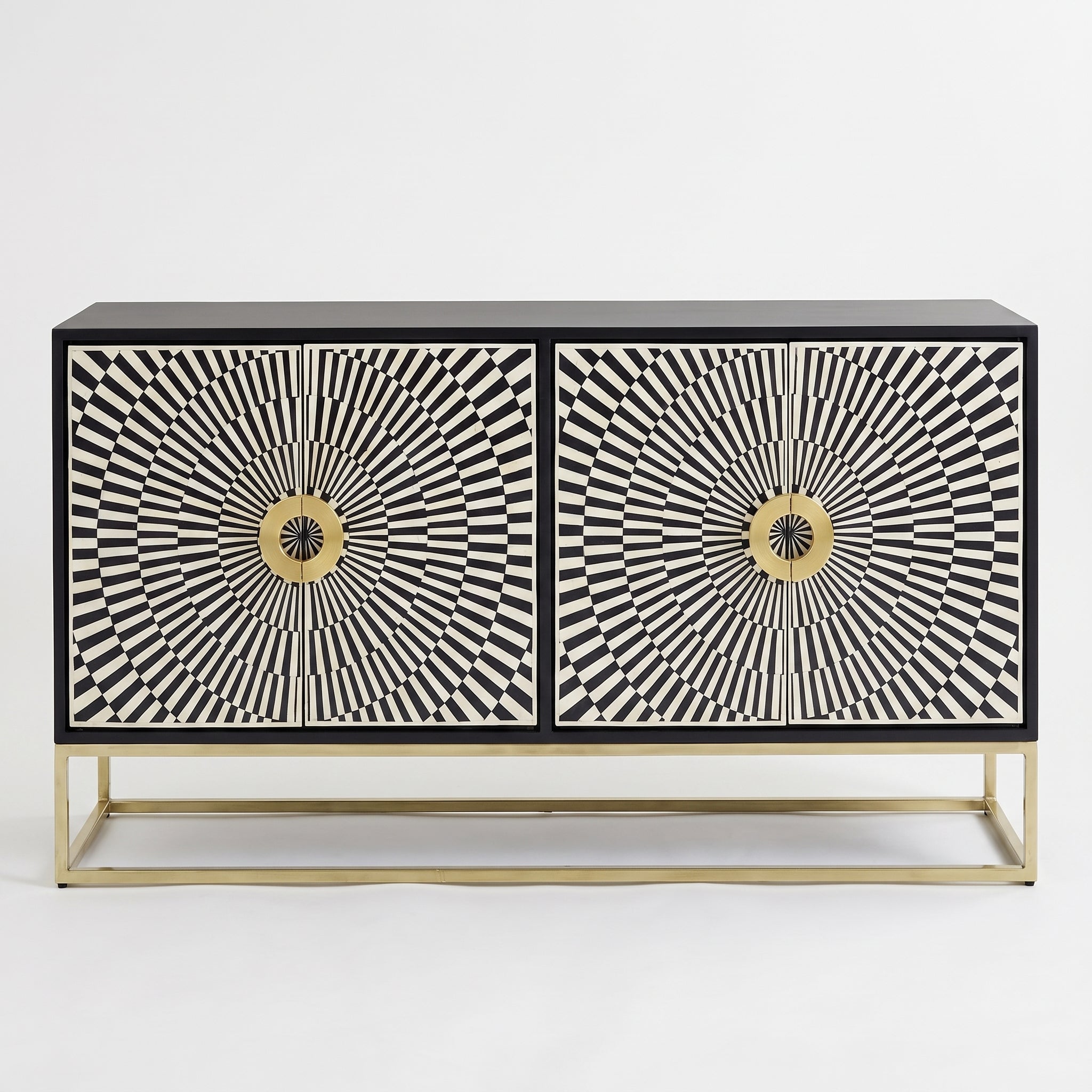 A modern two-door sideboard cabinet featuring black and white geometric sunburst patterns on the doors, a black top and base, and a slim gold metal frame, shown against a plain white background.