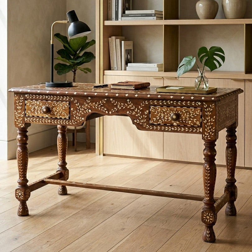 Decorative wooden desk in a room with a bookshelf and plants