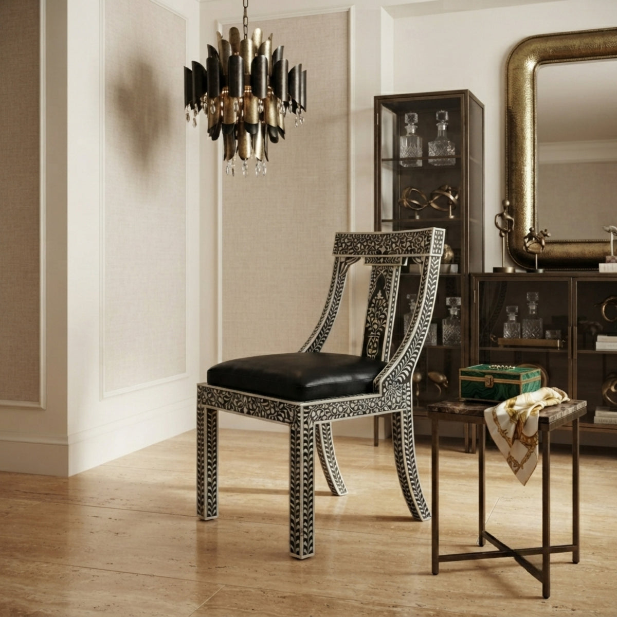 A luxury dining chair with a black leather seat and bone-inlay frame, styled in a classic elegant room with a chandelier, side table, and dark wood cabinet.
