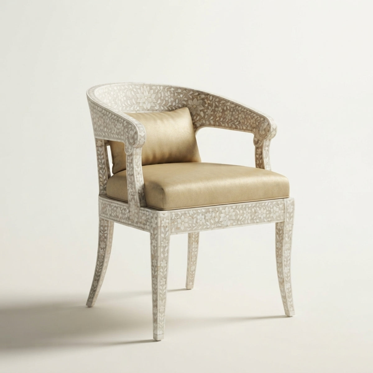 An elegant accent chair featuring a curved backrest and arms upholstered in textured beige fabric, supported by a frame inlaid with small metallic gold pieces, set against a plain off-white background.