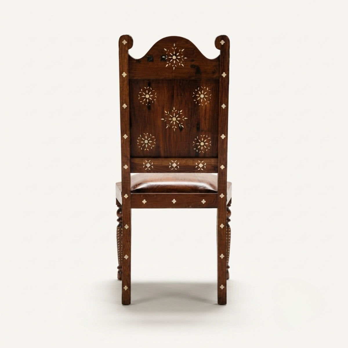 A dark brown wooden high-back chair with intricate gold-toned inlay star patterns on the backrest and seat, set against a plain light gray background.