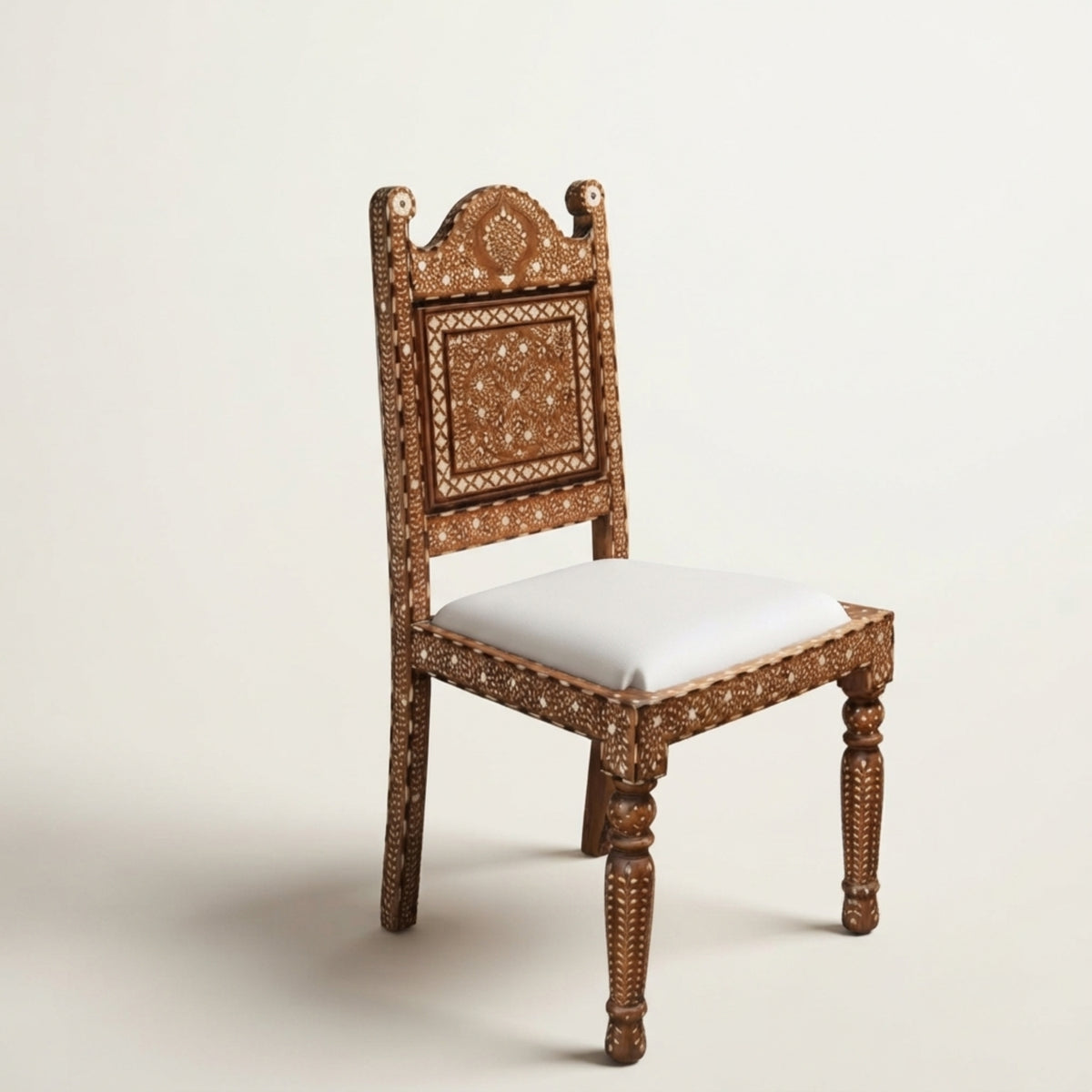 An ornate wooden dining chair featuring intricate brown and gold geometric inlay patterns on the carved frame, with a light beige cushioned seat, set against a plain off-white background.