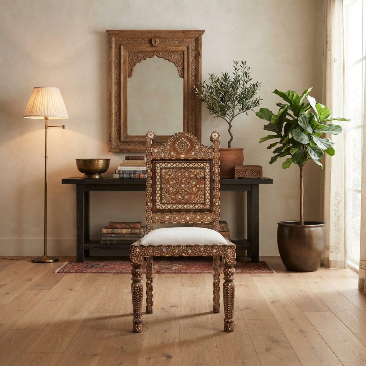 An ornate carved wooden dining chair with intricate inlay work and a white upholstered seat, positioned in a beautifully styled room with a console table, mirror, plants, and a floor lamp.