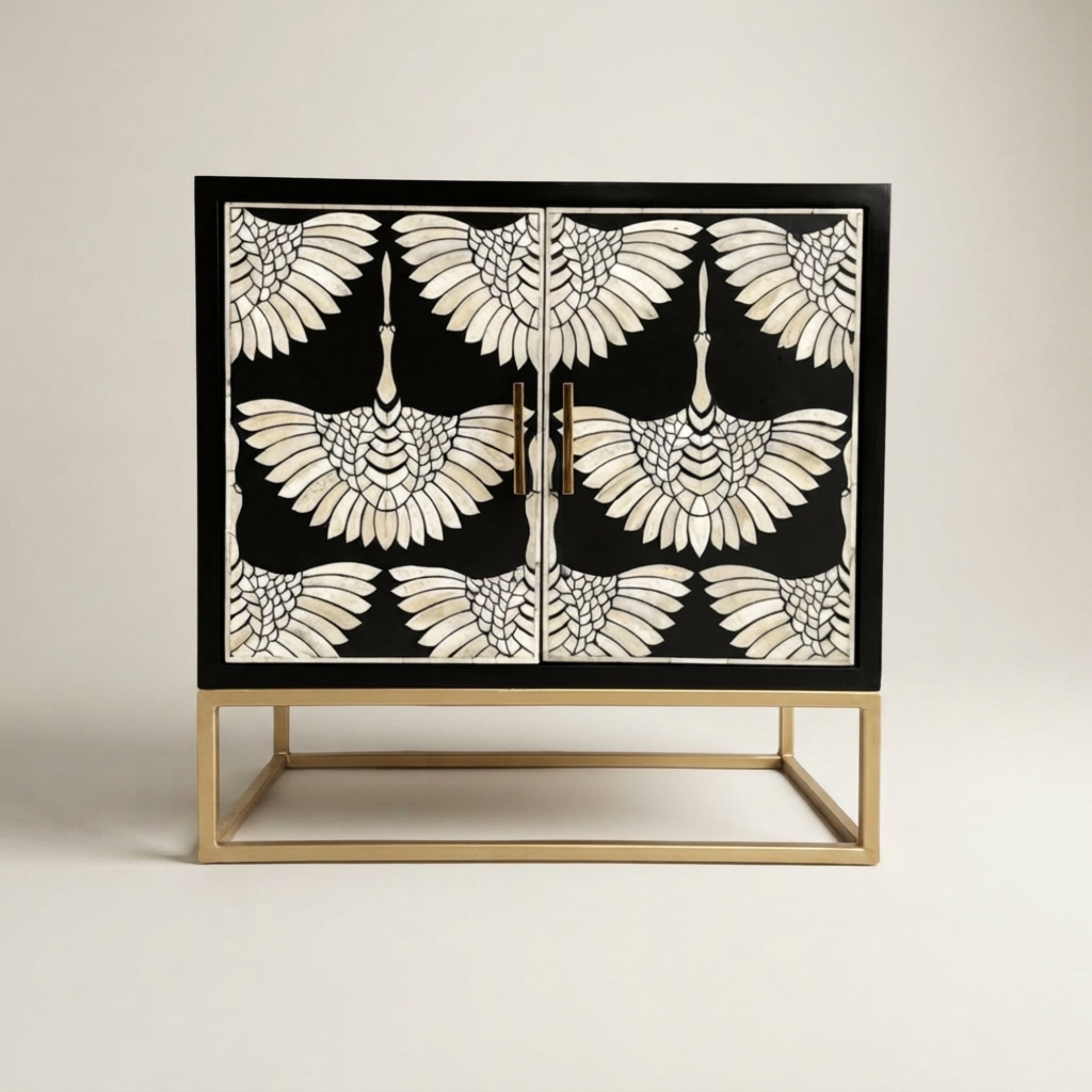 A two-door sideboard cabinet featuring a black and white mother-of-pearl swan pattern, supported by a gold metal frame base, set against a plain light beige background.