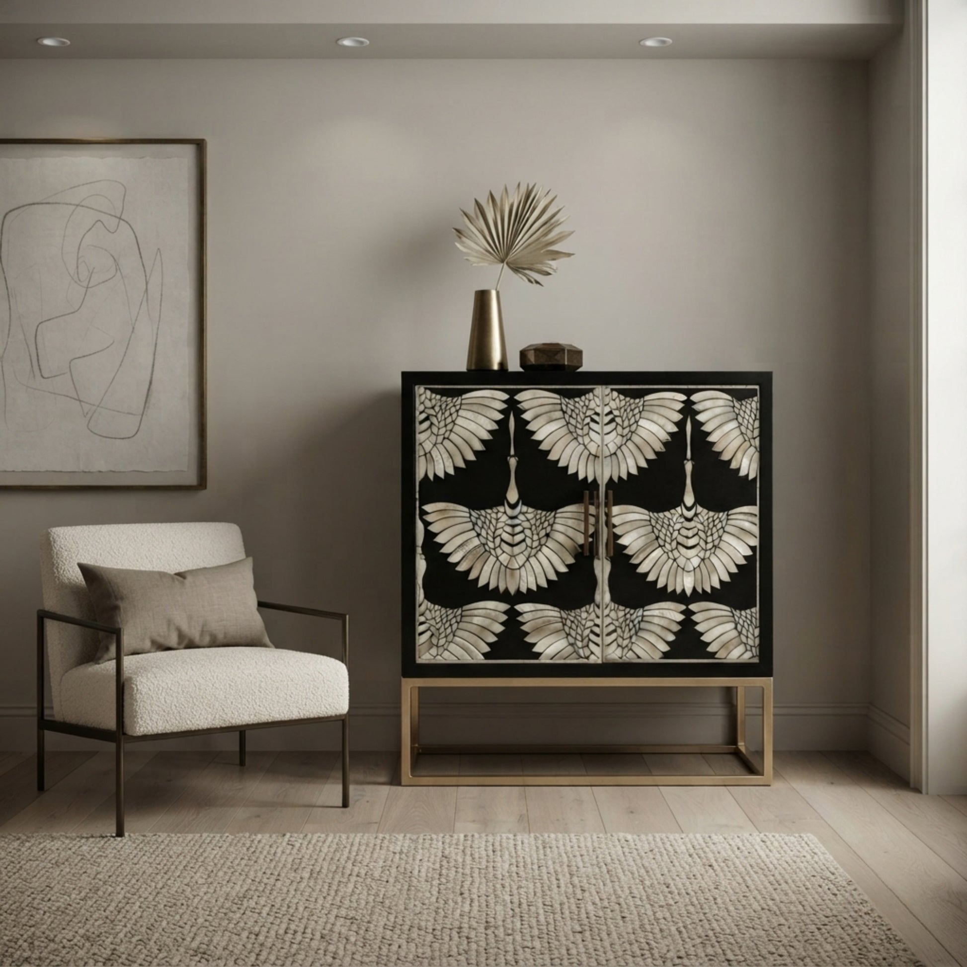 A modern sideboard cabinet with a black background and a detailed beige and white bird pattern on the doors, styled in a minimalist room next to a white armchair.