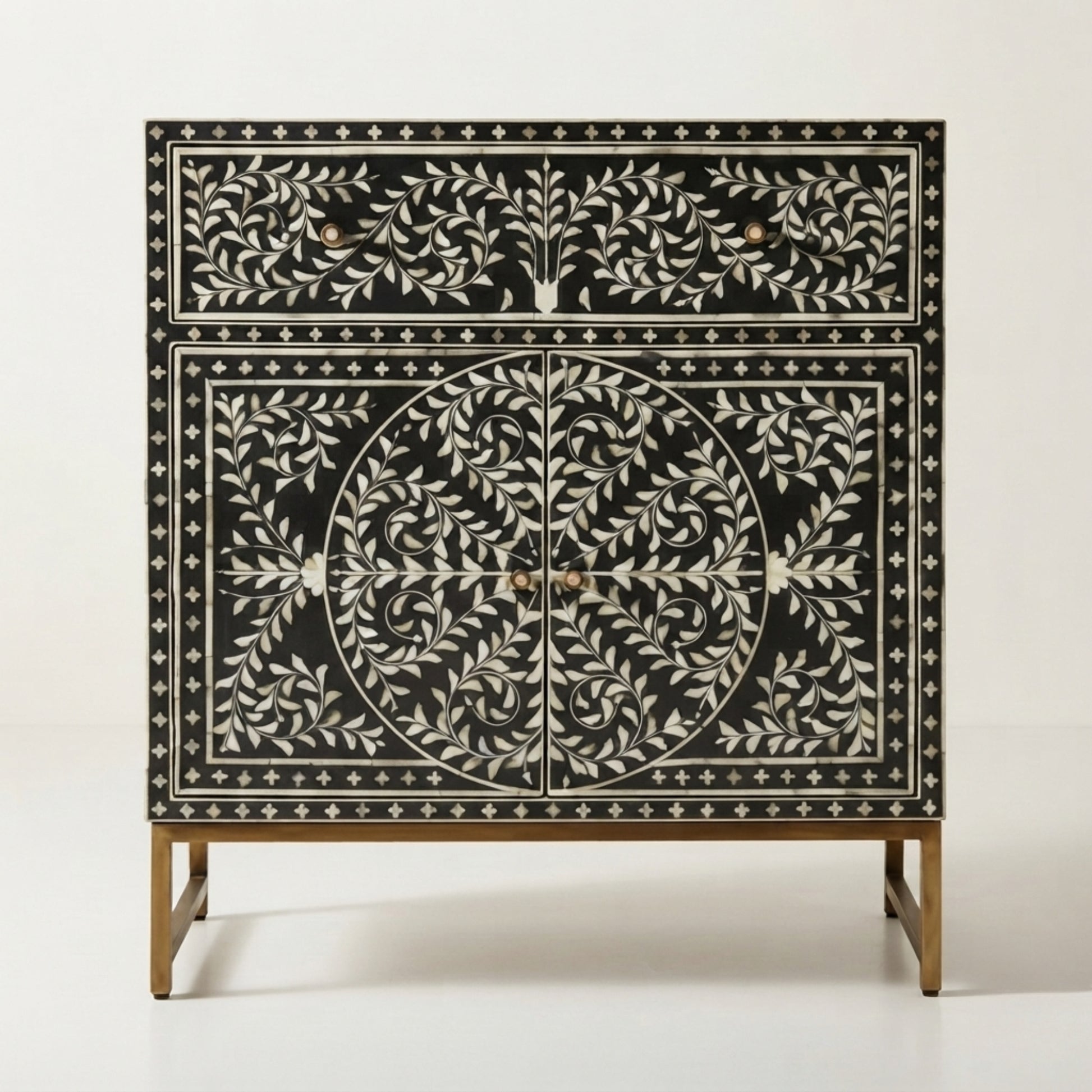 Black and white bone-inlay cabinet with gold-tone legs and handles, photographed against a clean white studio background.