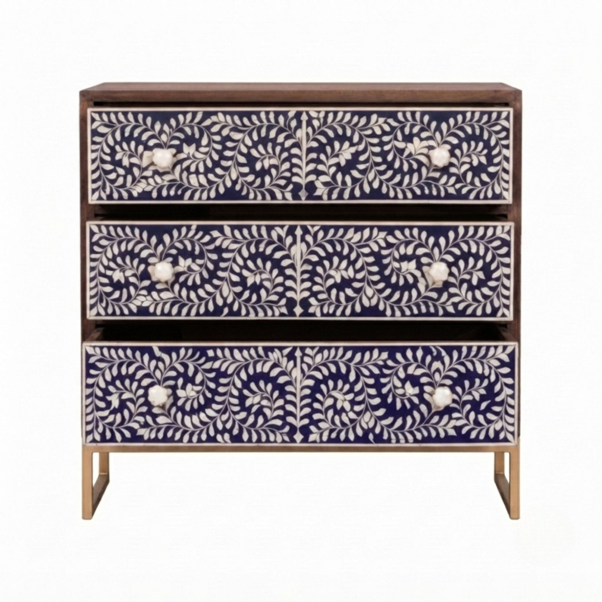 A three-drawer chest of drawers with dark wood framing and legs, featuring intricate white bone or shell floral inlays on the drawer fronts, set against a plain white background.