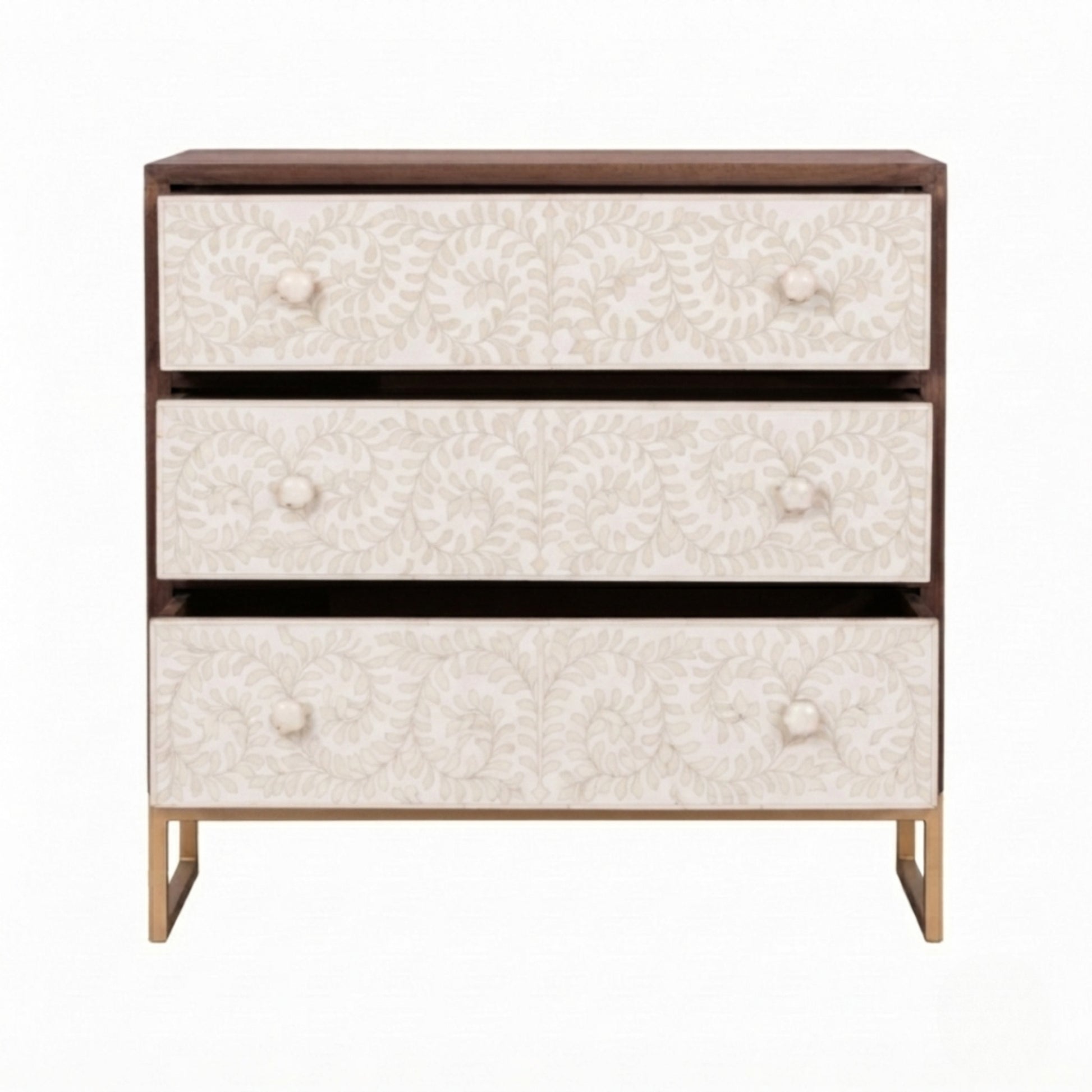 A three-drawer chest of drawers with a dark brown wood frame, cream floral patterned drawer fronts, and light gold legs, shown against a plain white background.