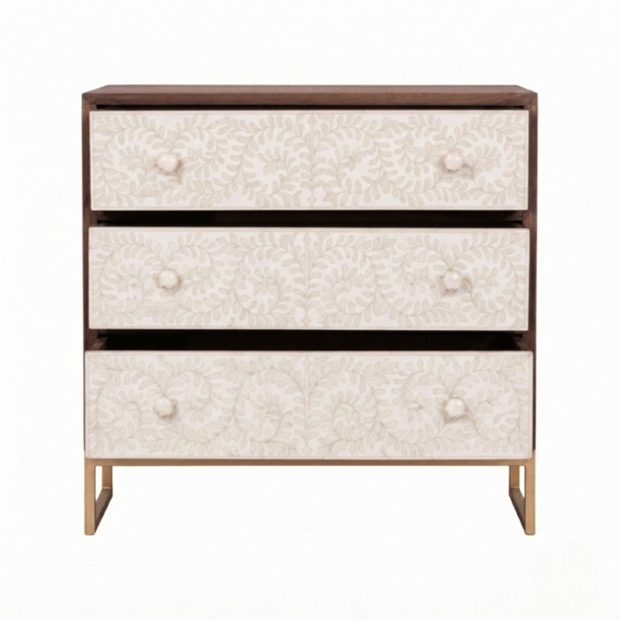 A three-drawer chest of drawers with a dark brown wood frame, cream floral patterned drawer fronts, and light gold legs, shown against a plain white background.