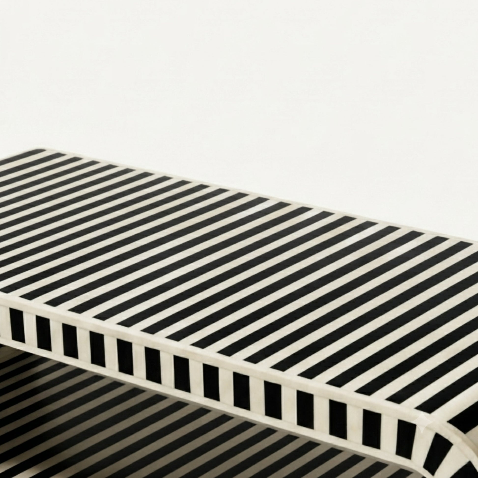 A modern rectangular console table with a bold black and off-white striped pattern on the top and a matching open lattice-style side frame, shown against a plain white background.