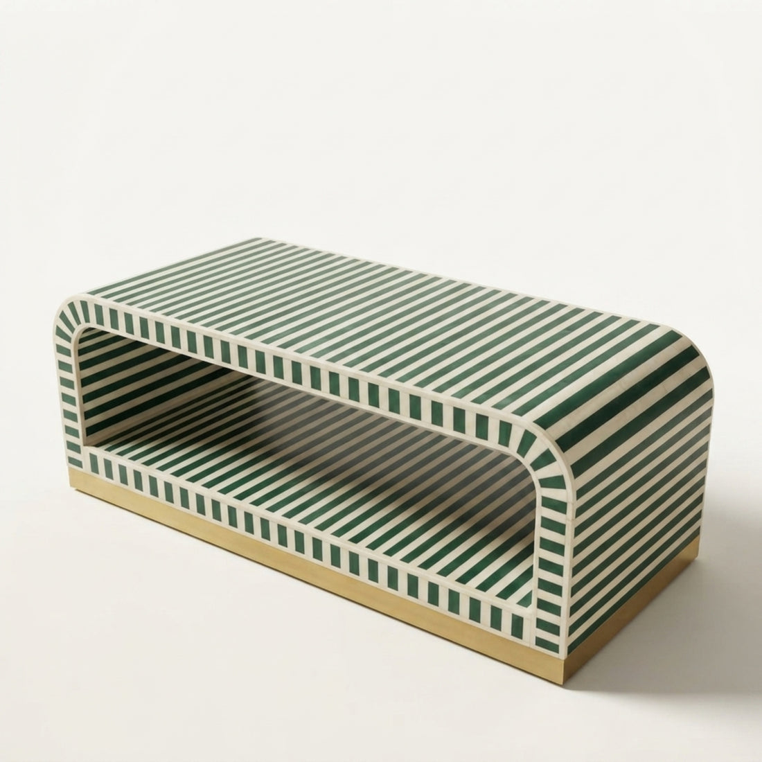 A modern rectangular coffee table with a green and white striped pattern and a gold-toned base, styled in a minimalist living room next to a white sofa.