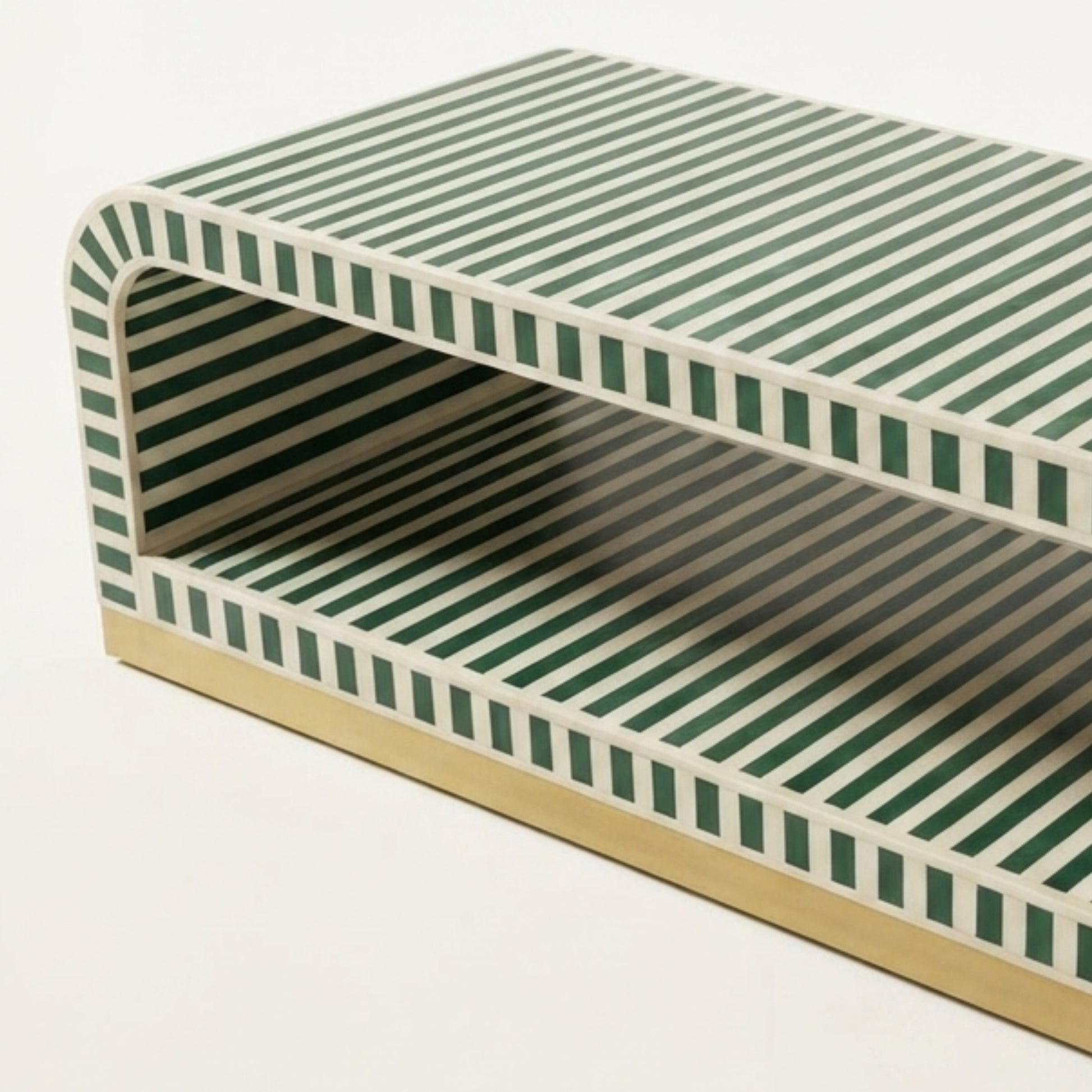 A modern open-front storage bench or shelf with a green and white striped pattern on the top and sides, and a light beige base, shown on a plain white background.