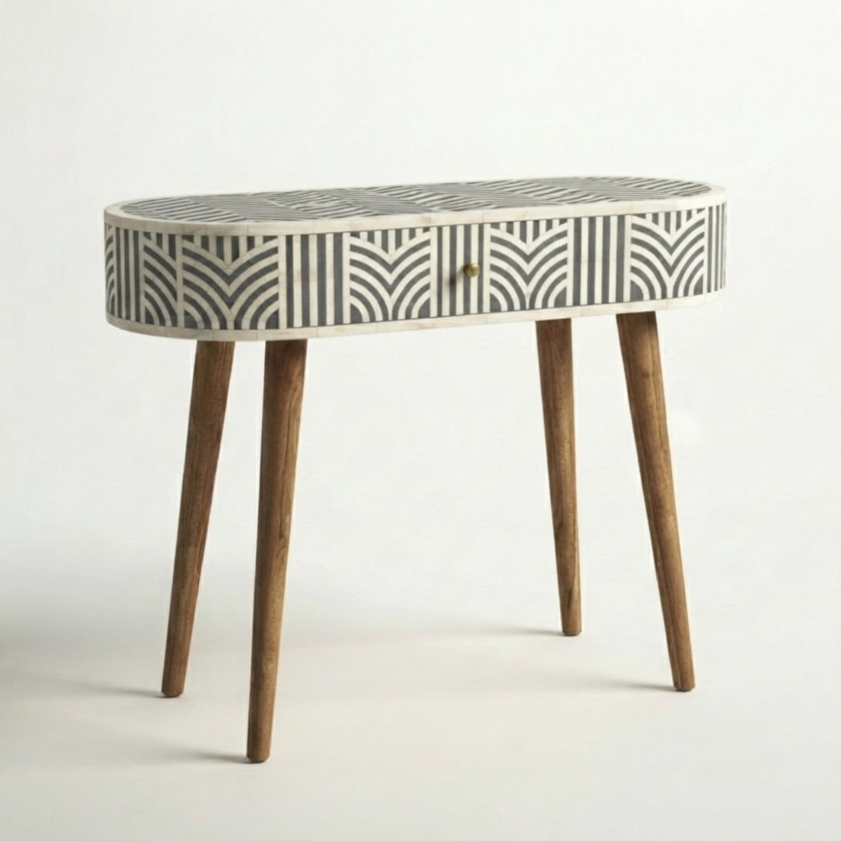 An oval console table with a bone-inlay patterned top and four tapered wooden legs, shown against a plain white studio background.