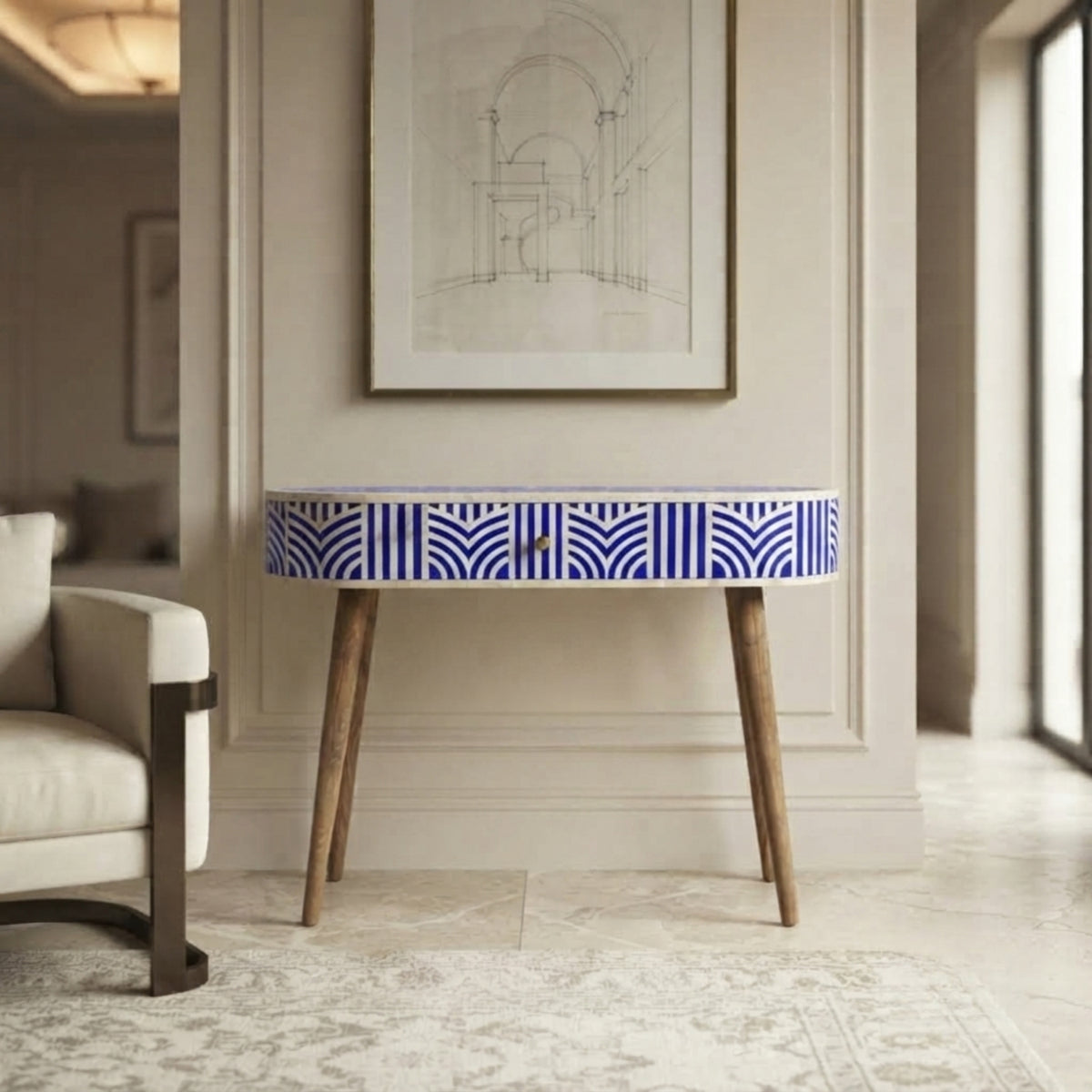 A console table with a blue and white geometric patterned drawer front and light wood legs, styled in a modern living room setting.