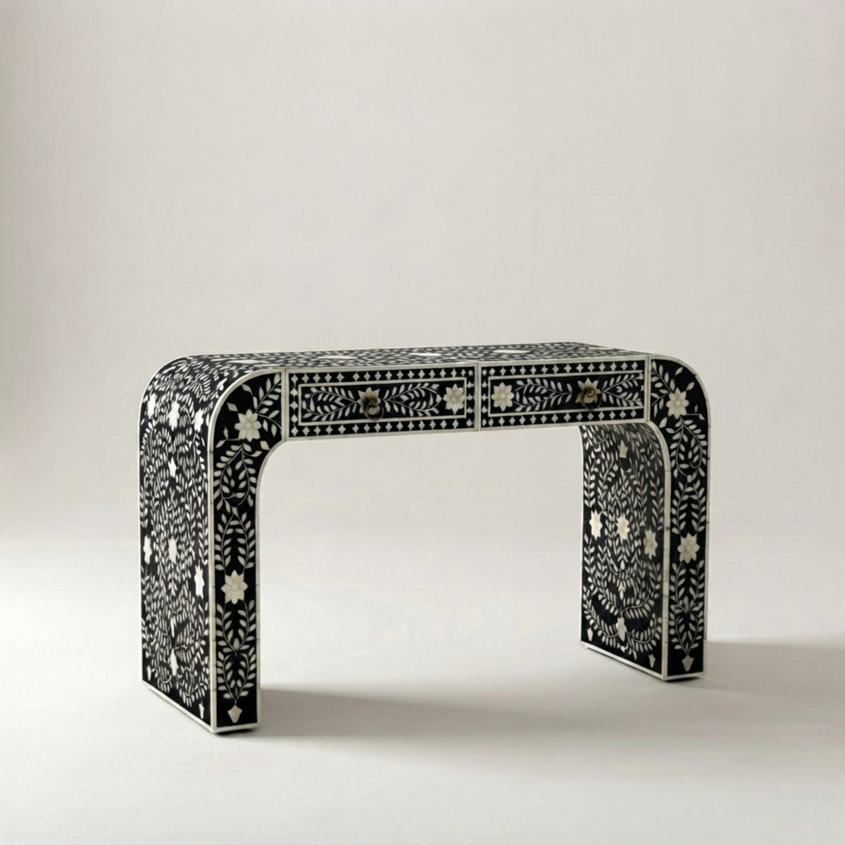 A console table with a black and white bone-inlay pattern, featuring two drawers on the front, photographed against a neutral light gray background.