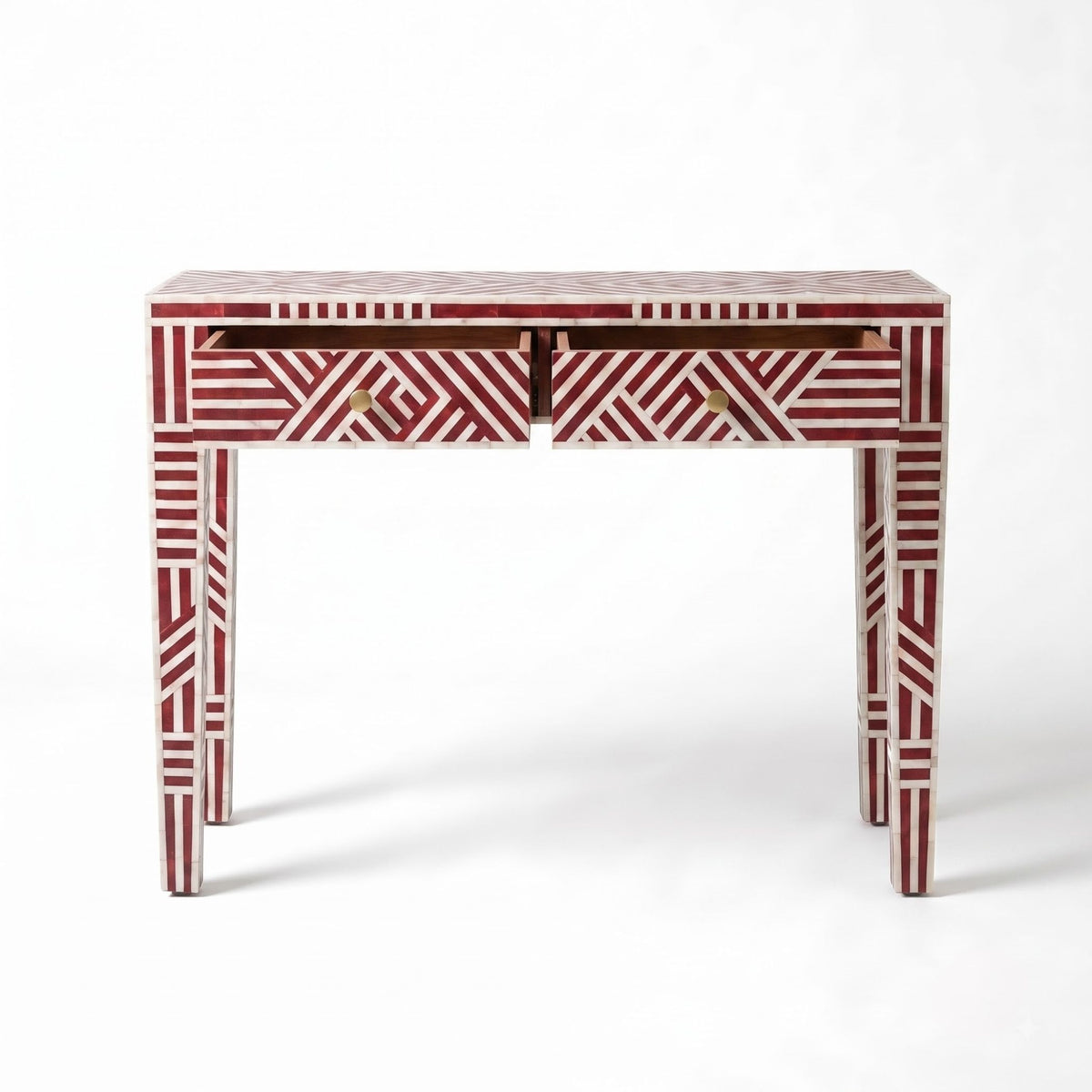 A two-drawer console table featuring a red and white geometric bone-inlay pattern, with brass drawer pulls, photographed against a clean white background.